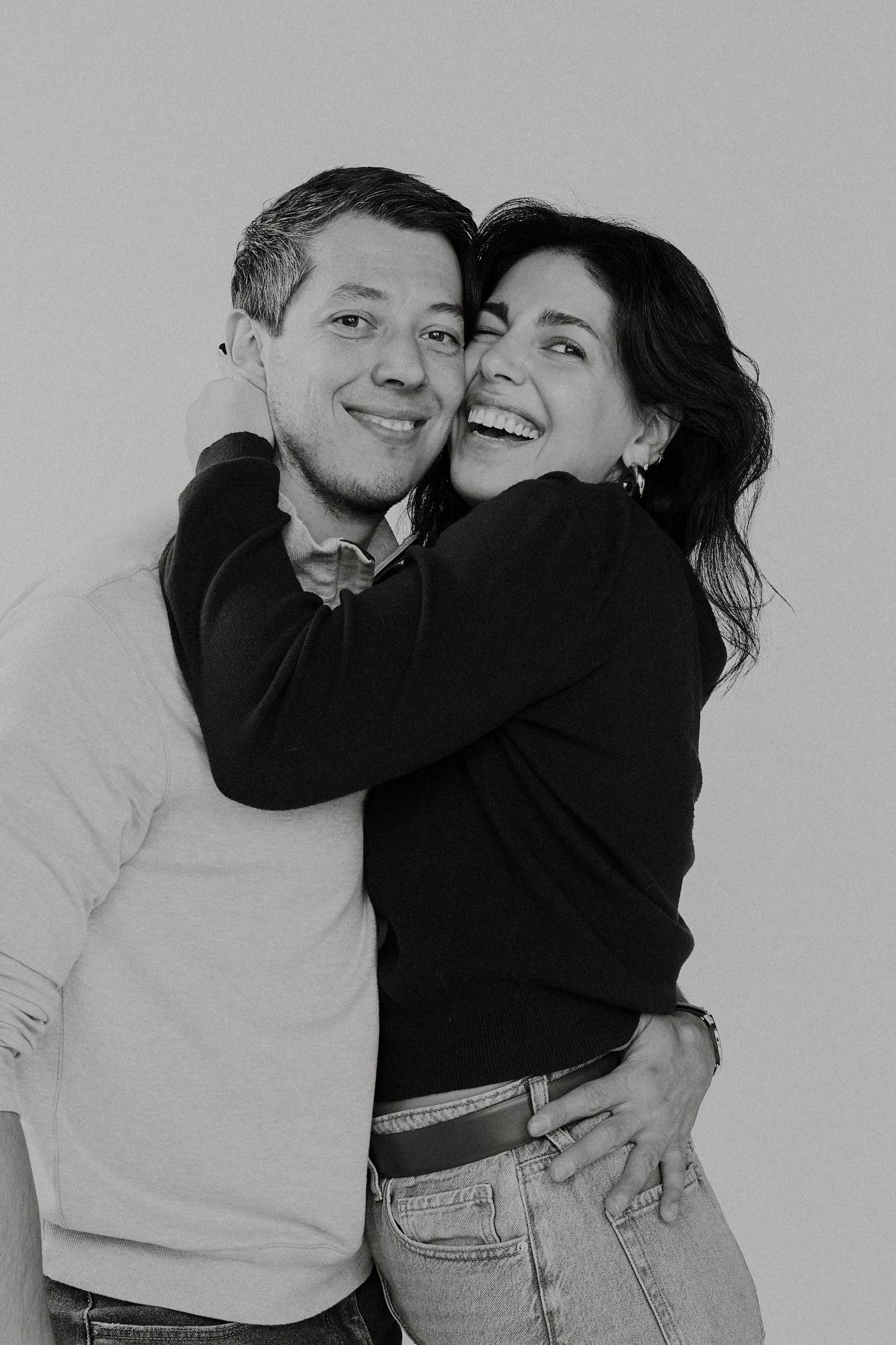 Black and white photo series capturing intimate moments between a couple in casual wear.
