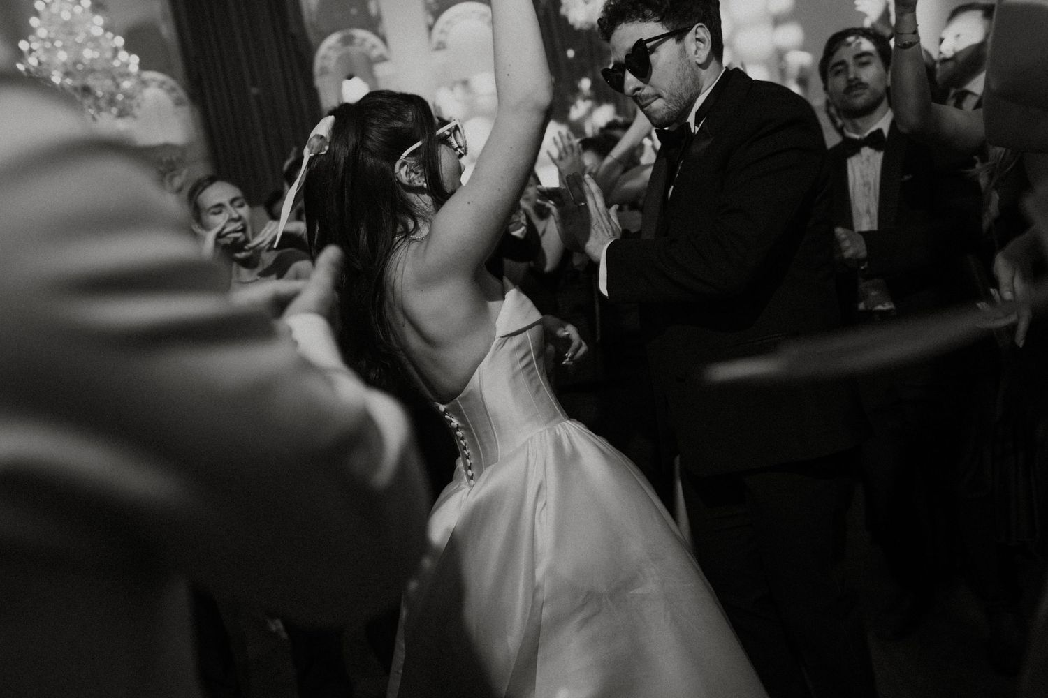 A black and white photo sequence showing a couple dancing together at a wedding reception.