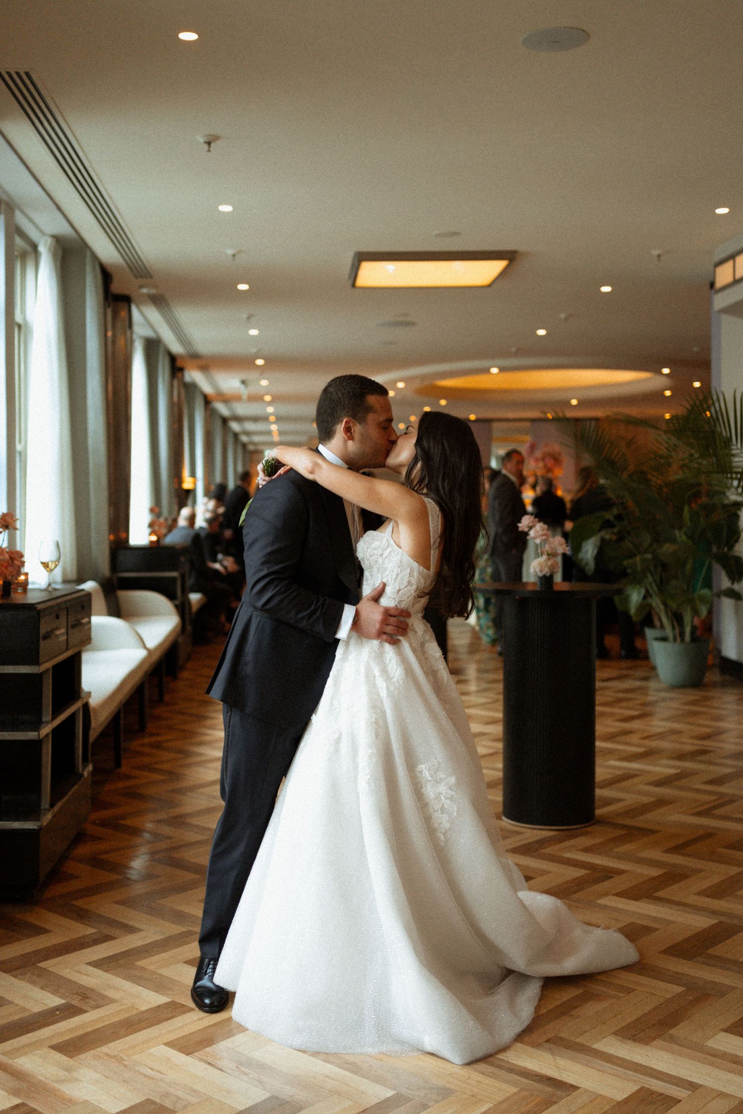 A romantic first dance sequence at an elegant wedding reception with a chevron patterned floor.