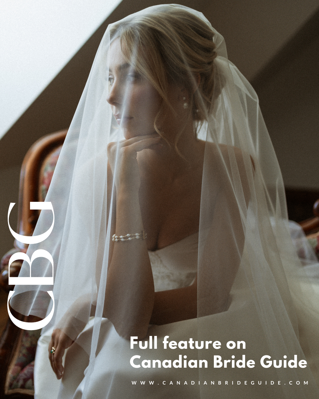 A bride in a white wedding dress and flowing veil poses elegantly in a moody, atmospheric bridal portrait.