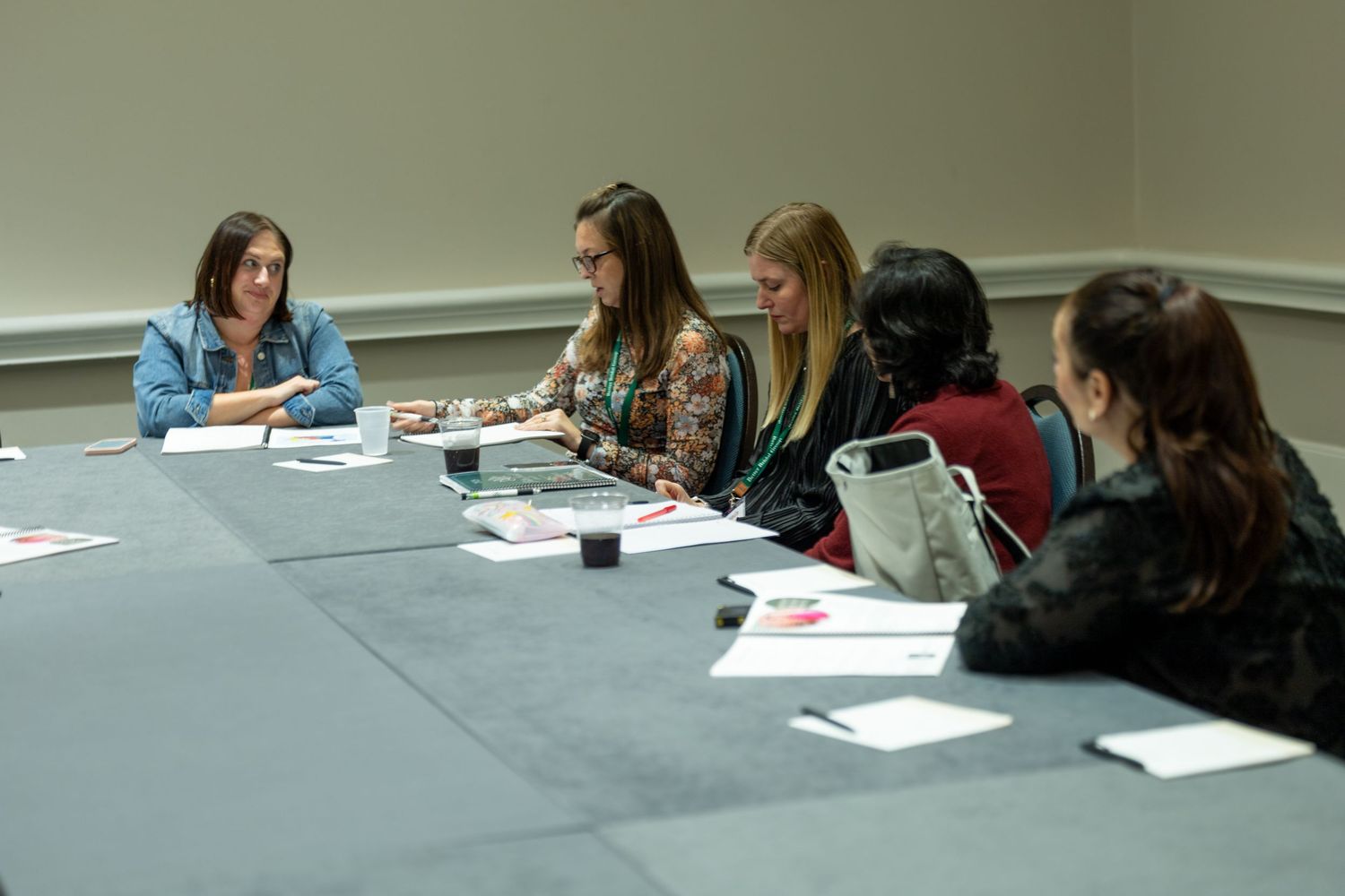 Women sitting around a conference table during a professional meeting or workshop session.