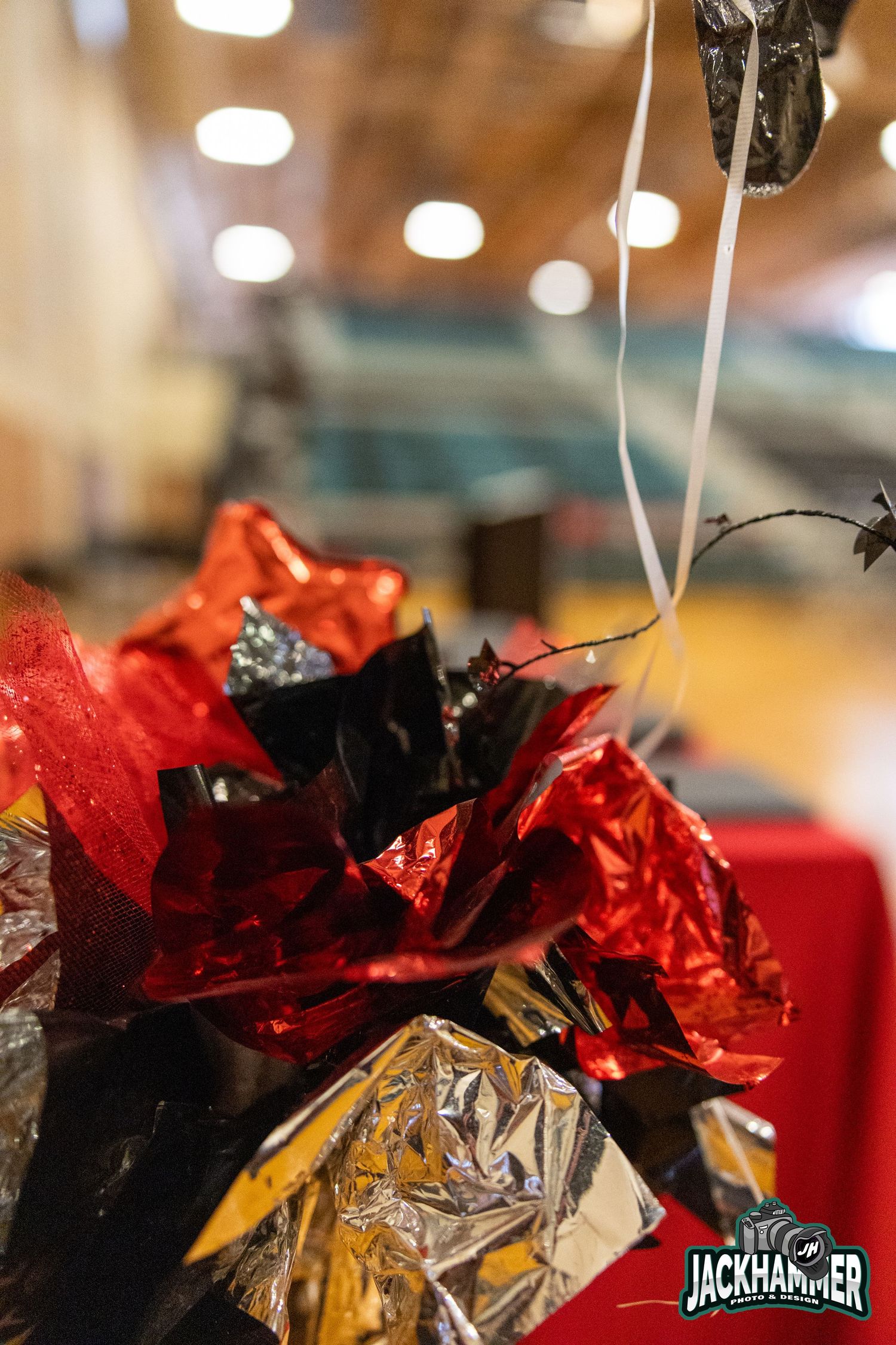 Red and silver metallic foil balloon bouquet decoration at a Jackhammer indoor event.