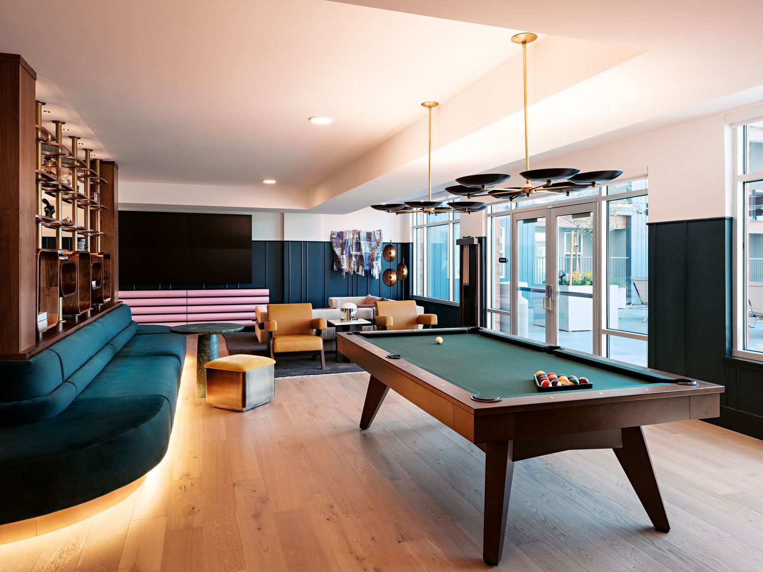 Game room featuring pool table and lounge seating in modern office space.