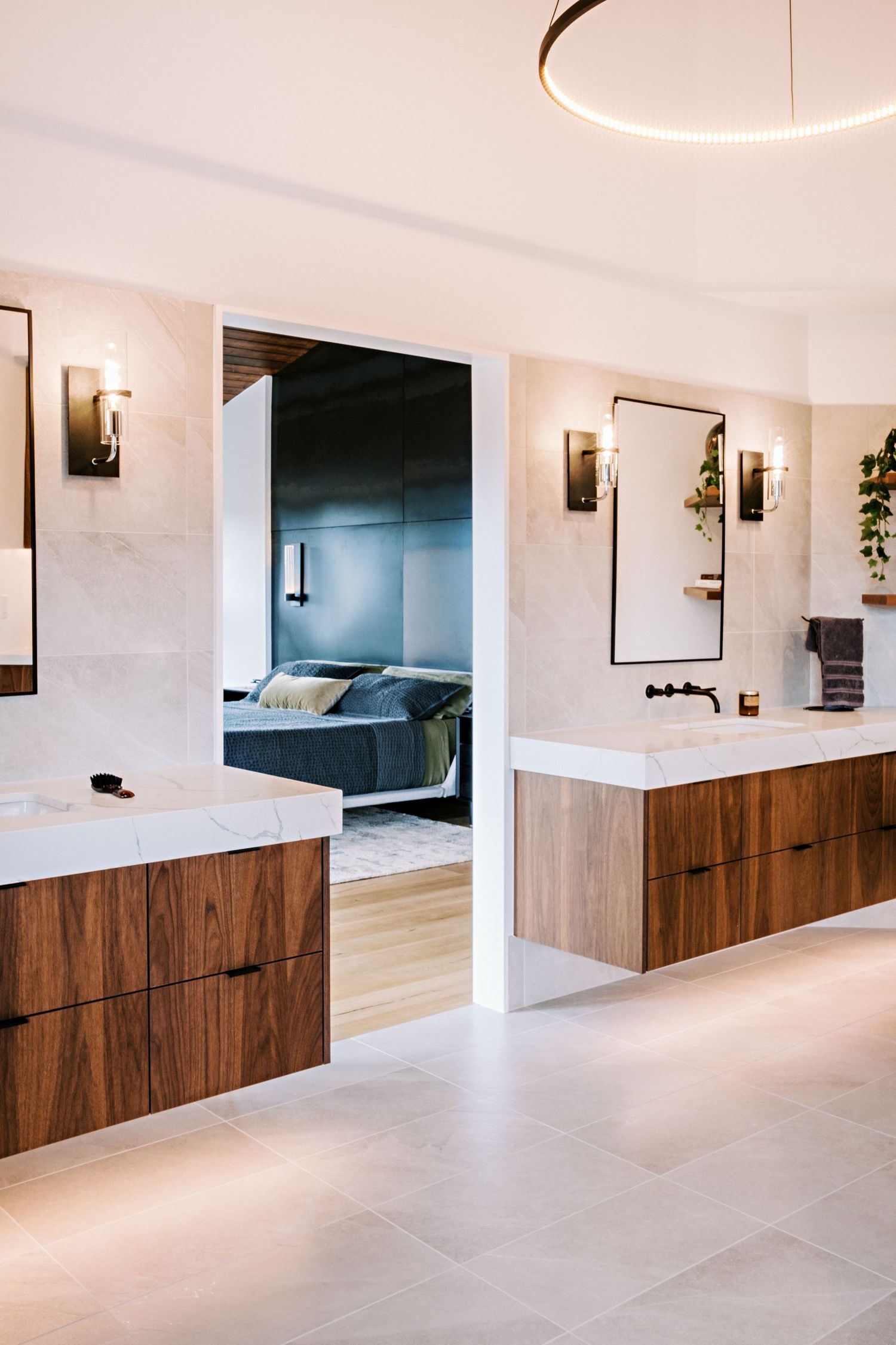 Sleek hallway featuring walnut wood cabinets and white walls with modern wall sconces.