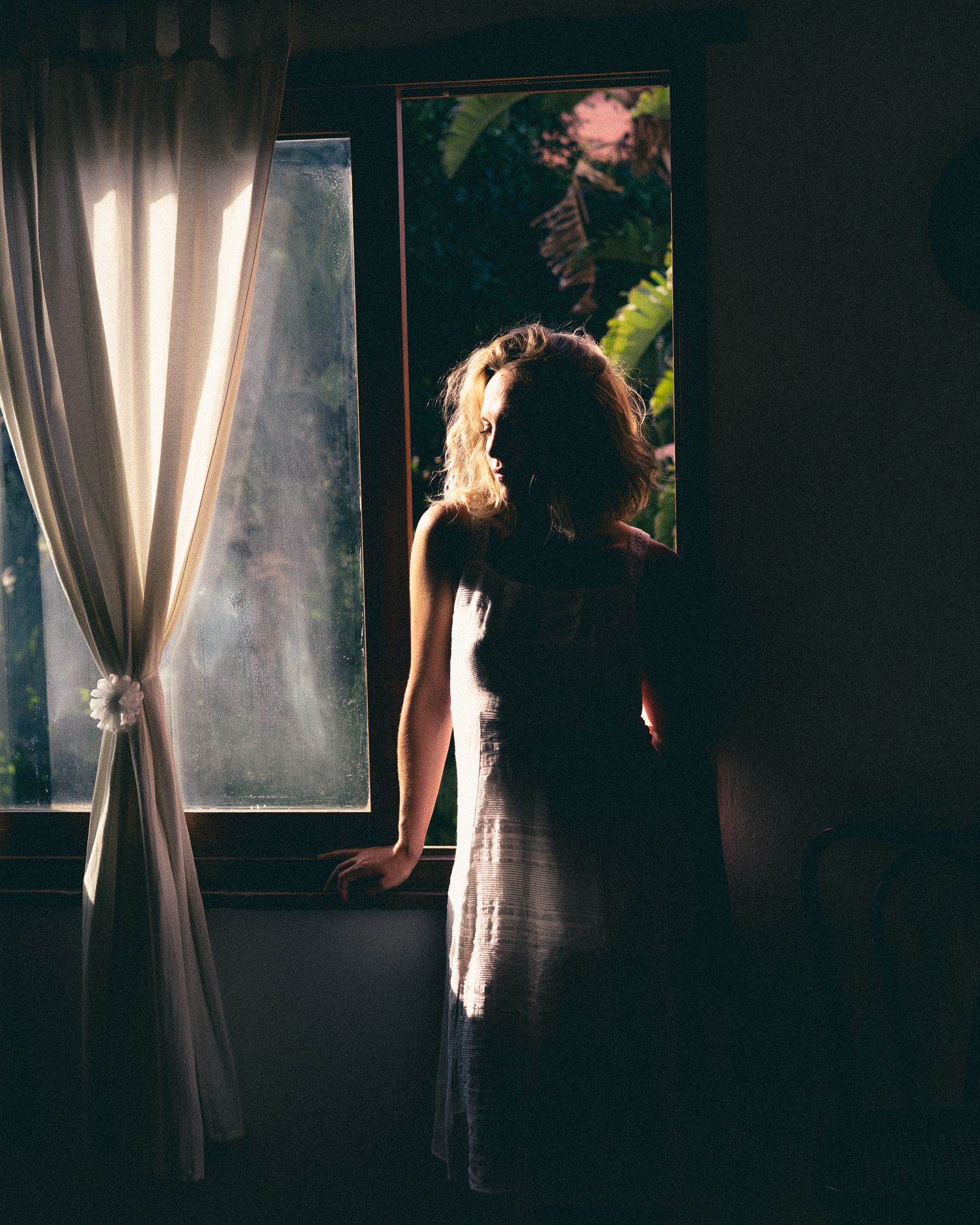 A series of dark moody photographs showing silhouettes against bright window light creating a dramatic atmospheric effect.