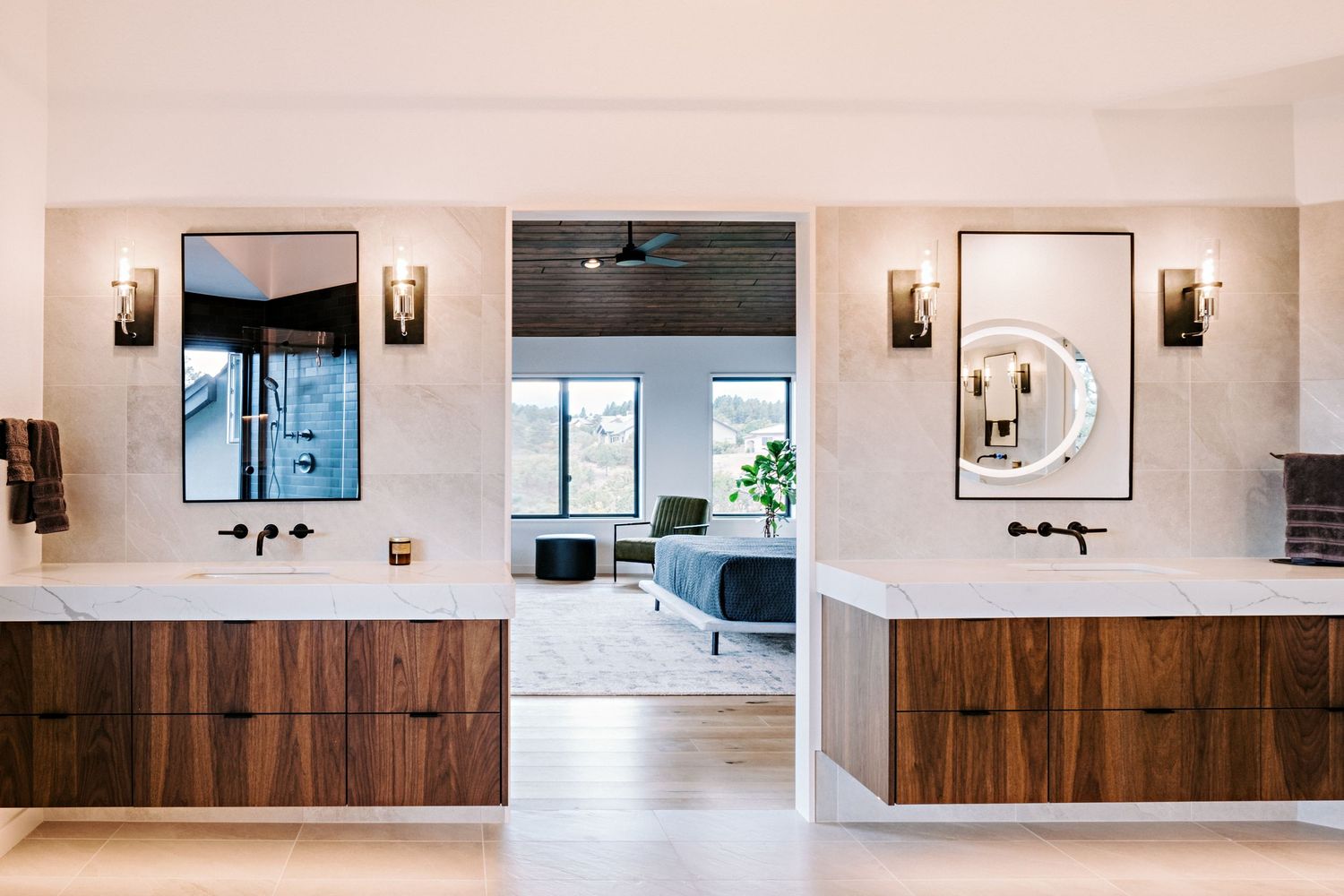 Long white hallway with wooden accents and wall sconces creating a clean, contemporary aesthetic.