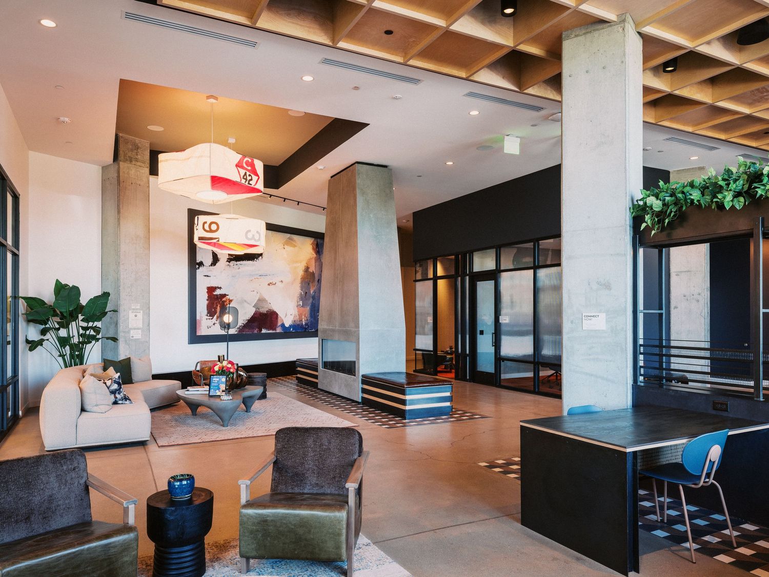 Contemporary office interior with wood ceiling beams and minimalist design elements.