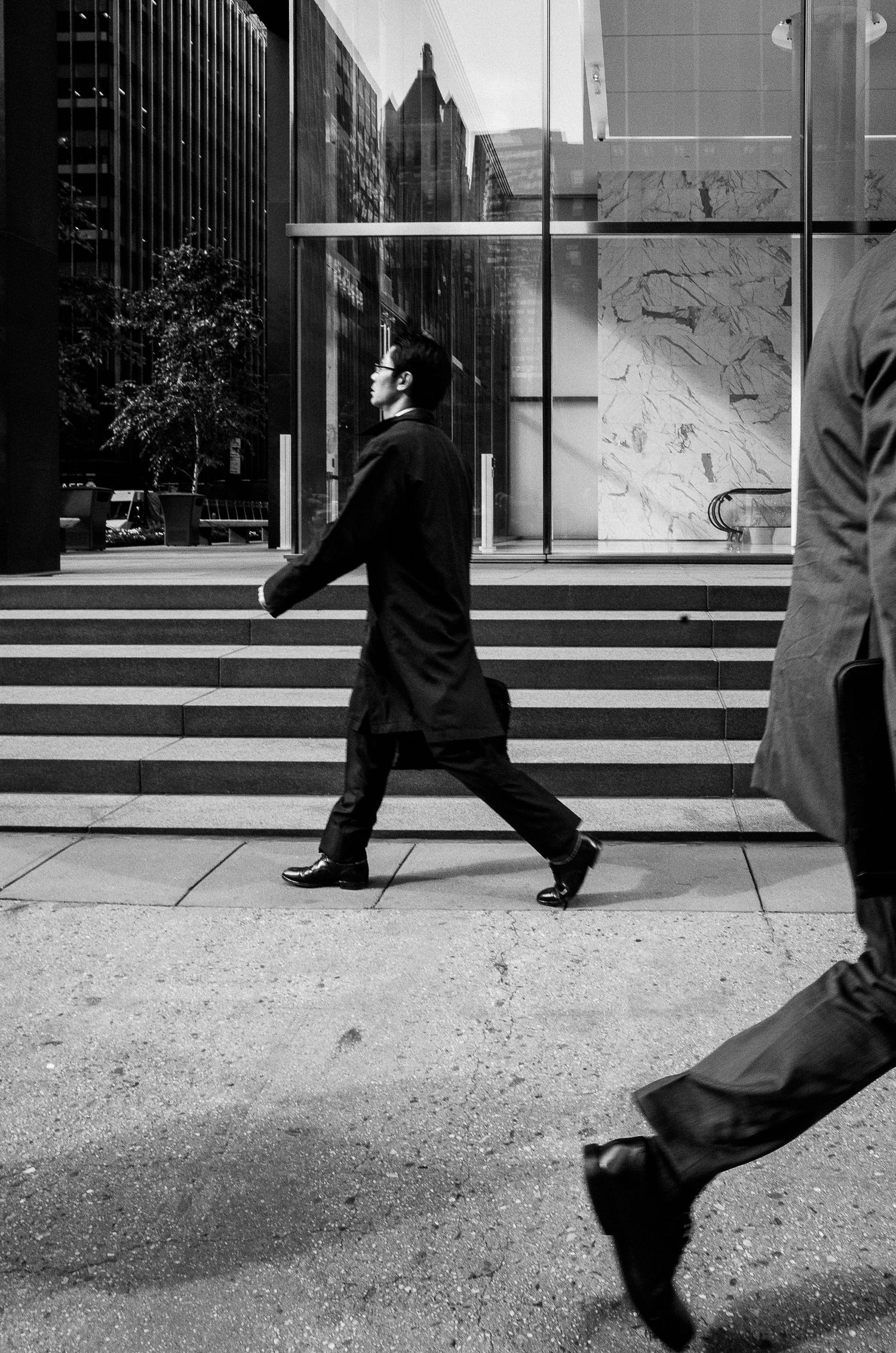 A sequence of black and white photos showing legs walking up concrete steps in an urban setting.