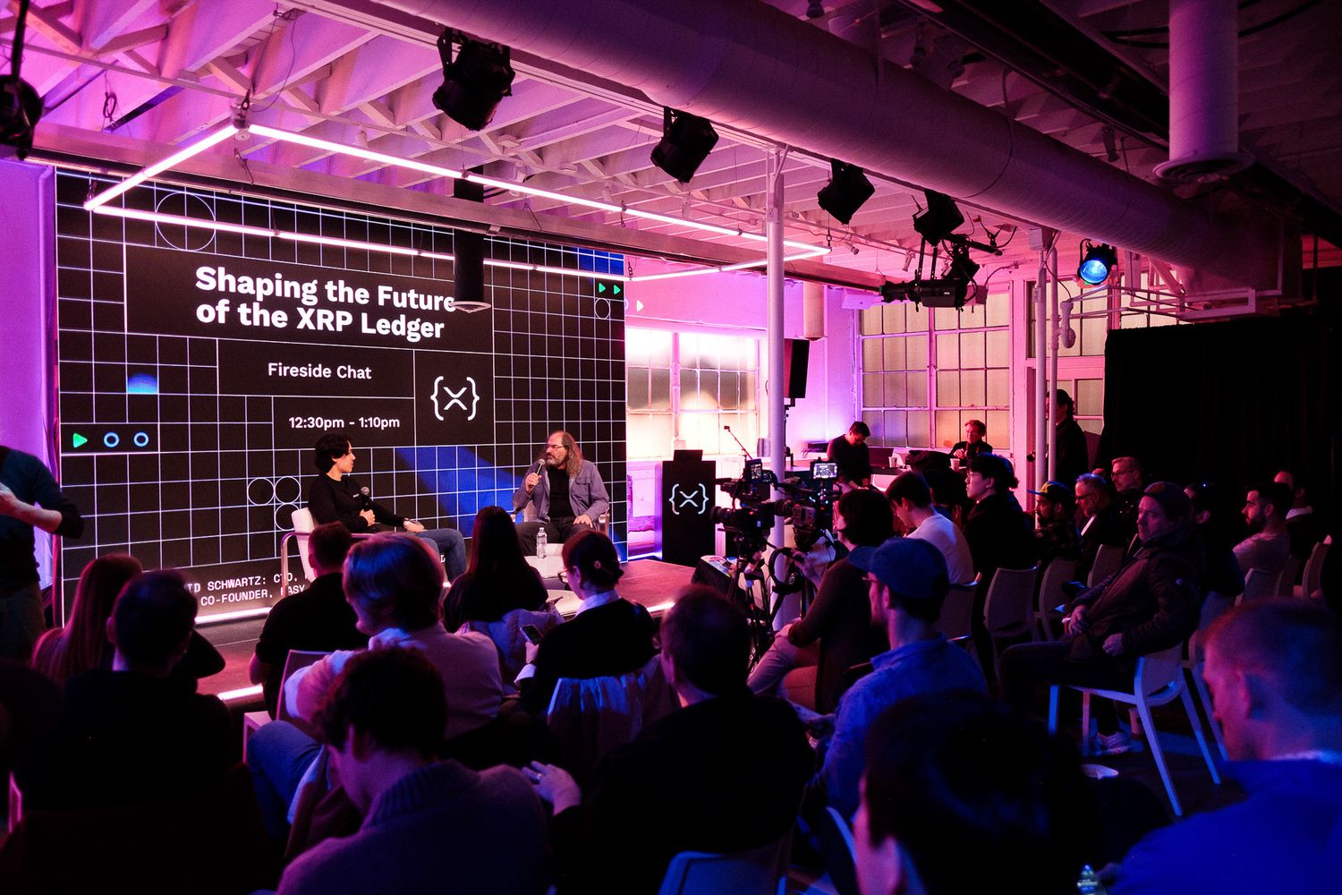 Panel discussion on shaping the future of the XRP Ledger at a tech conference event.