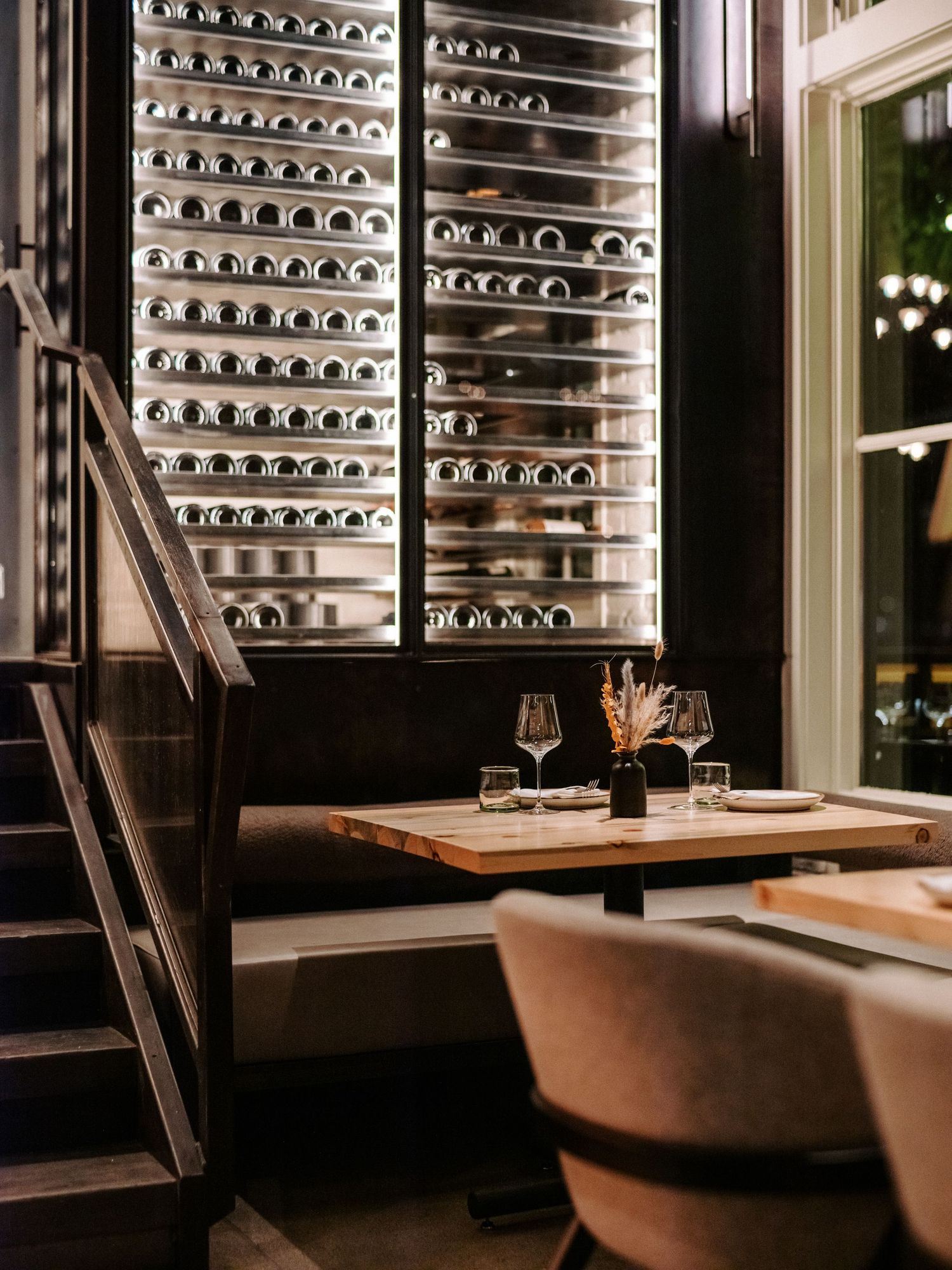 Upscale wine cellar dining area with temperature-controlled storage and intimate seating.