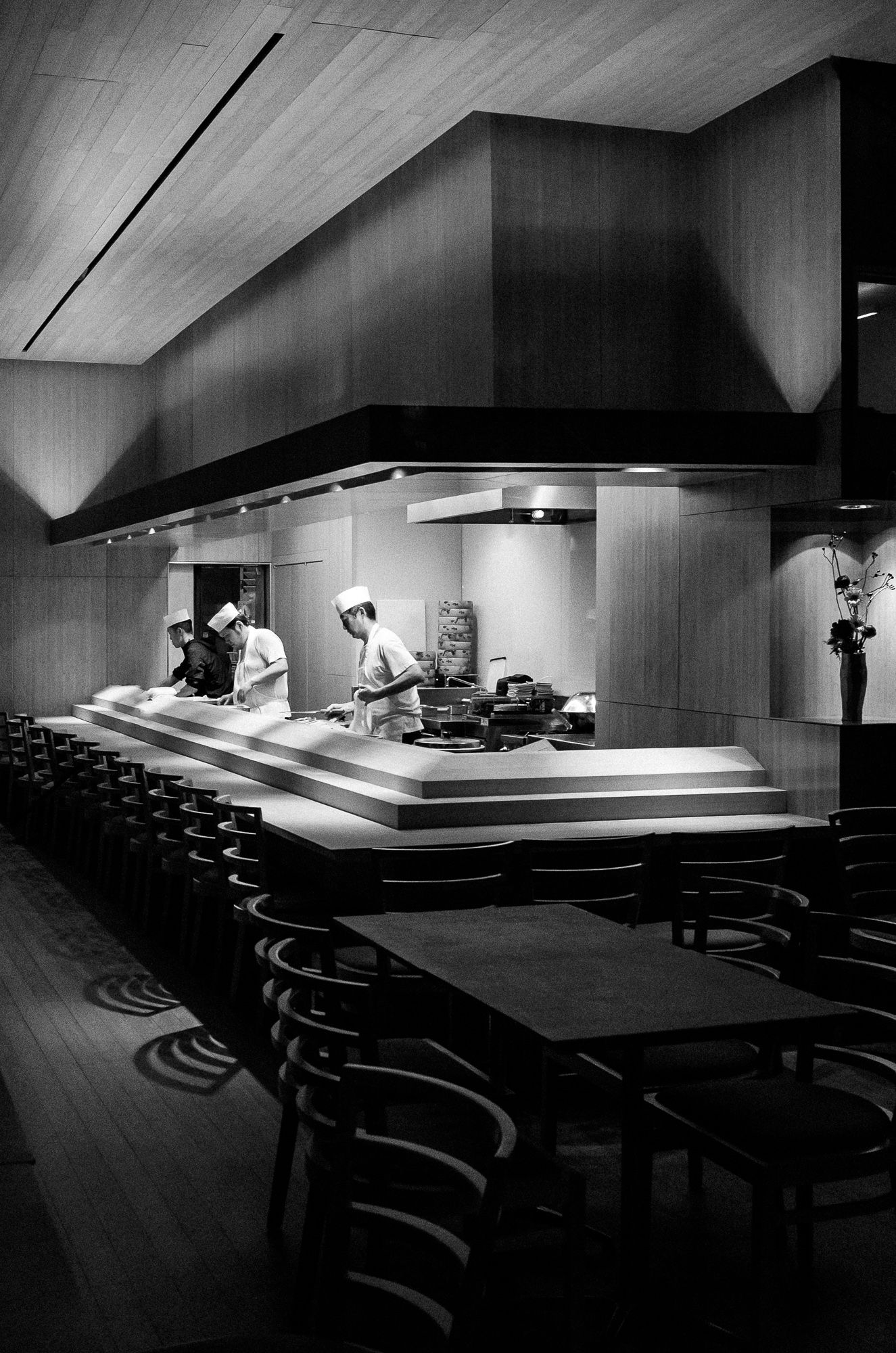 Dark auditorium with tiered seating and dramatic lighting on an empty stage.