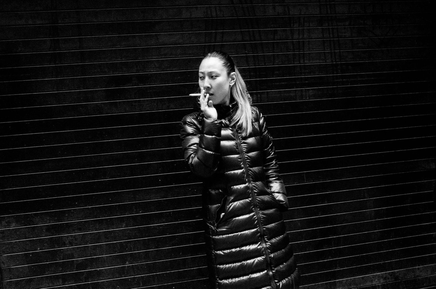 A series of black and white photos showing a person wearing a striped sweater against a dark background.