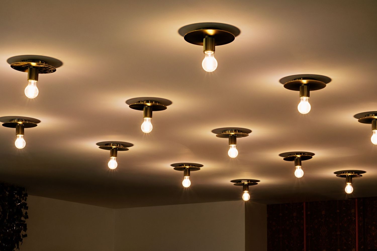 Vintage-style ceiling fixtures with exposed bulbs creating warm atmospheric lighting.