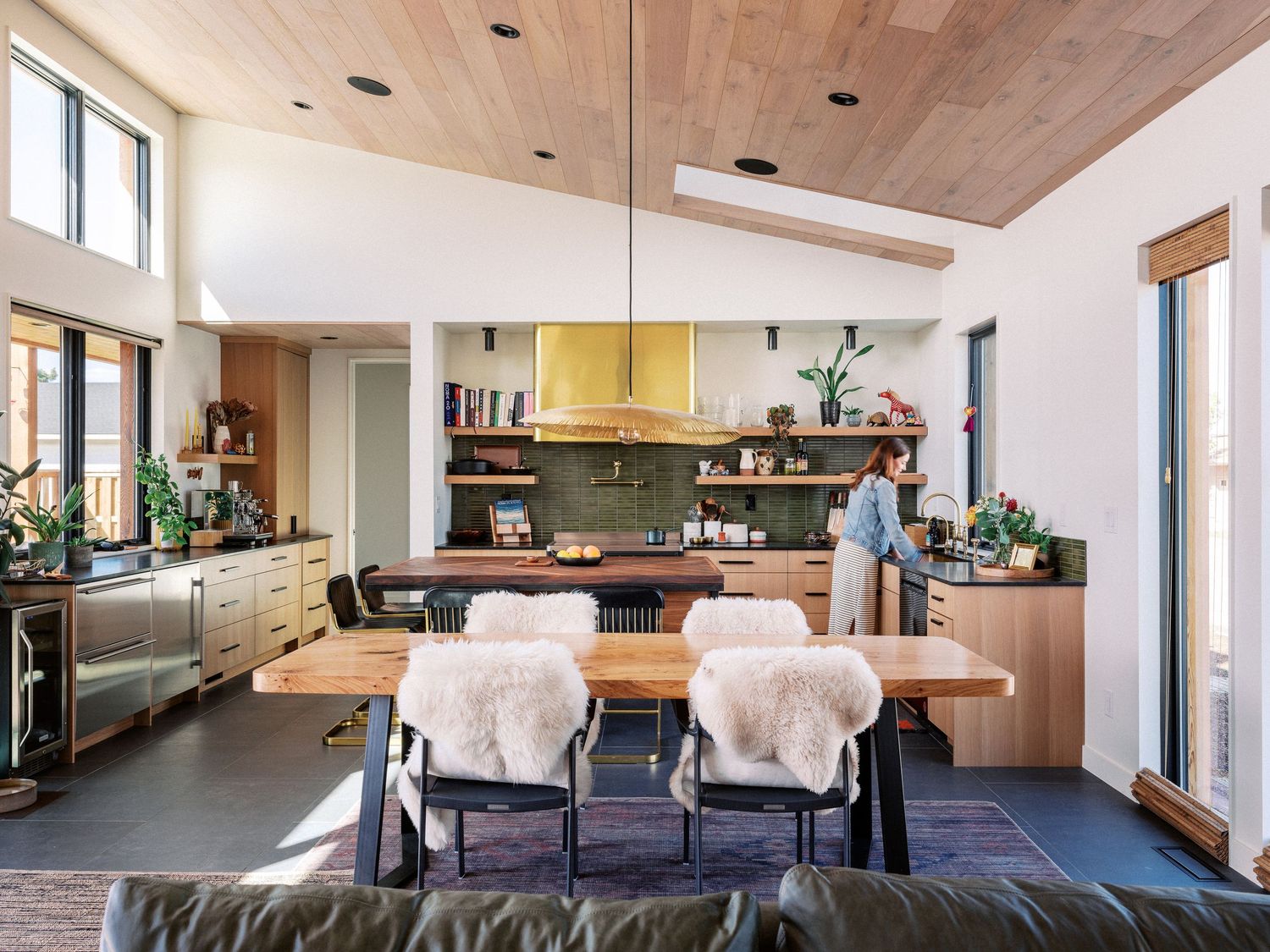 Spacious modern living room with vaulted wood ceiling and open floor plan design.