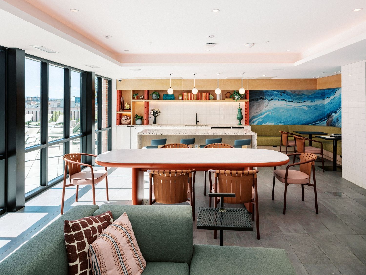 Modern lounge area with comfortable seating and large windows providing natural light.