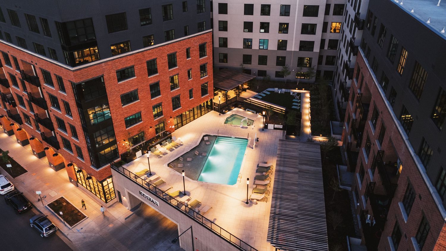 Panoramic view of urban apartment complex with swimming pool and courtyard amenities.