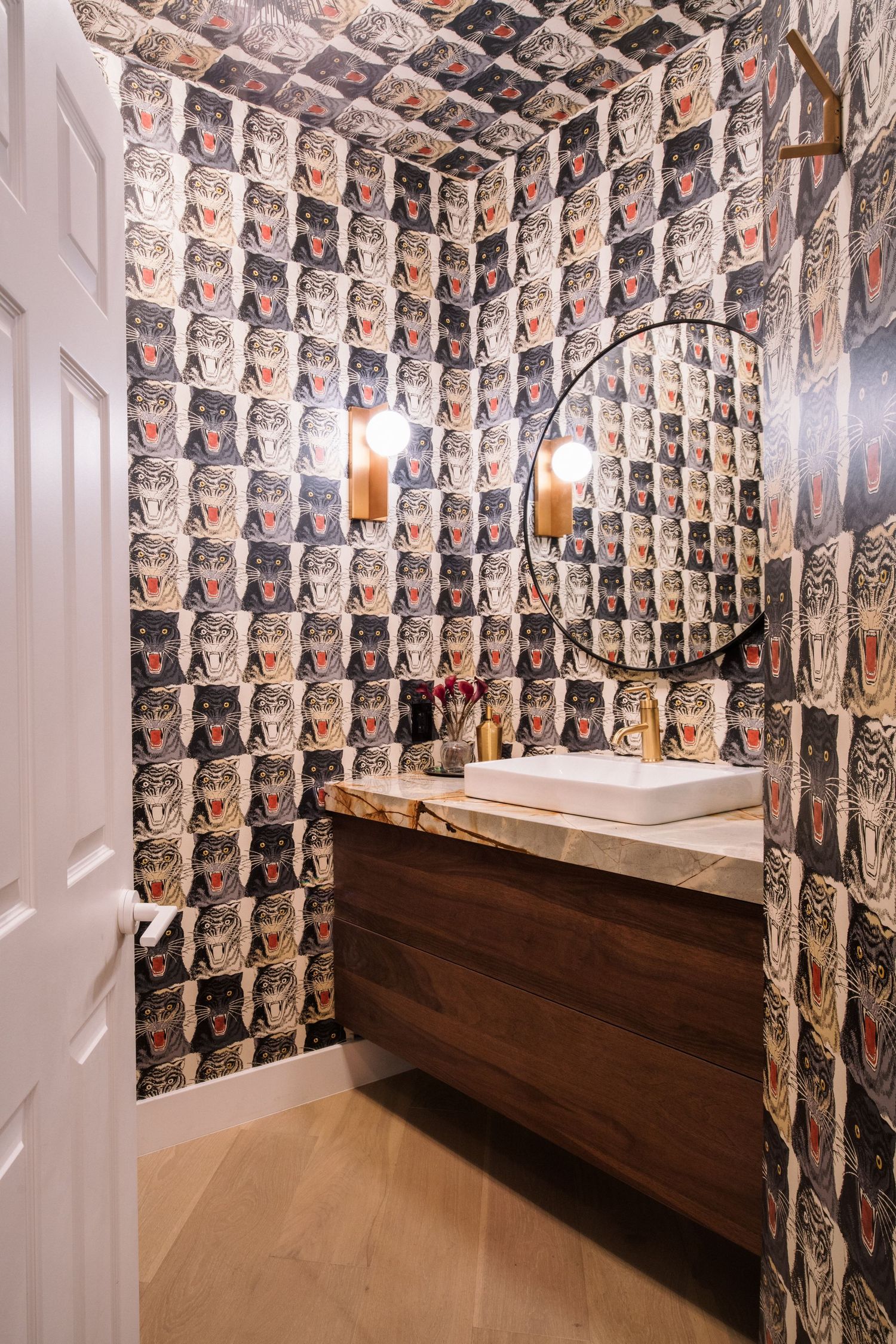 Unique room with walls covered in vintage photographs and wooden bench seating.
