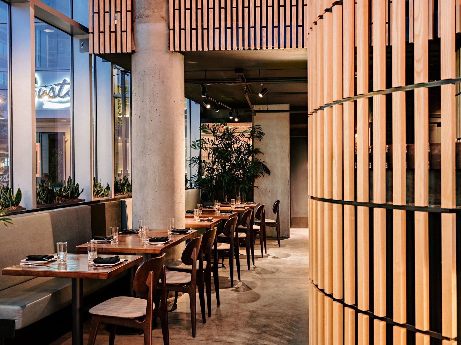 Restaurant interior featuring elegant wood paneling and modern dining furniture.