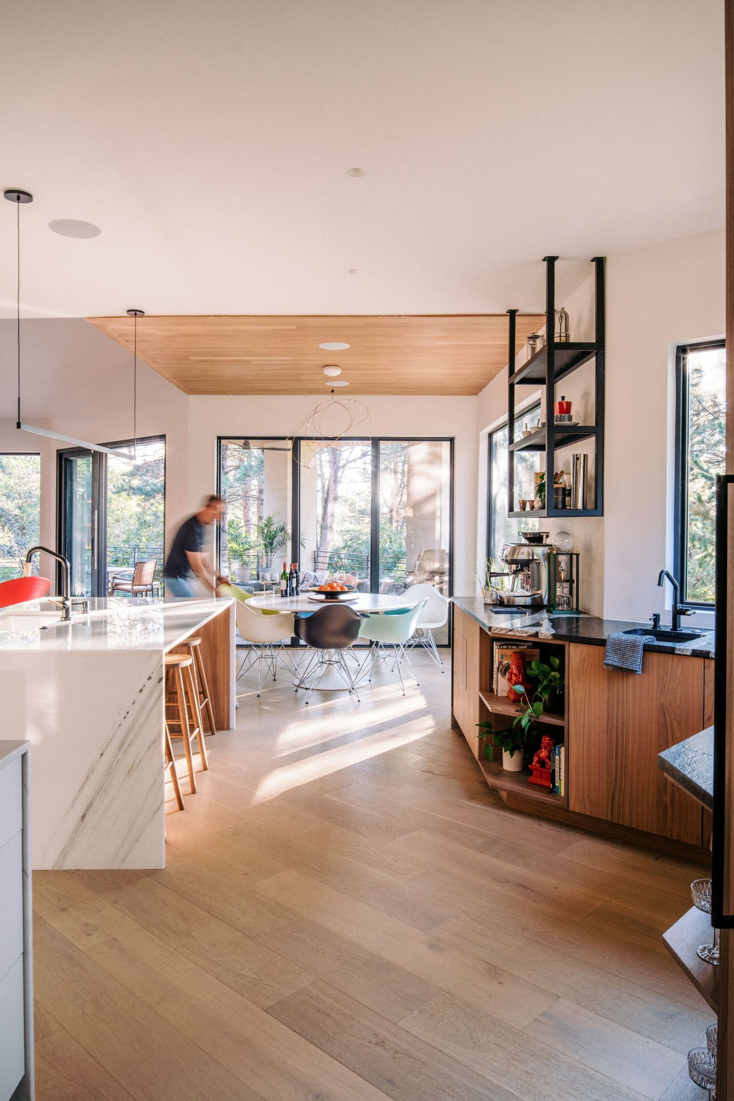 Open concept living space with hardwood floors and floor-to-ceiling windows.