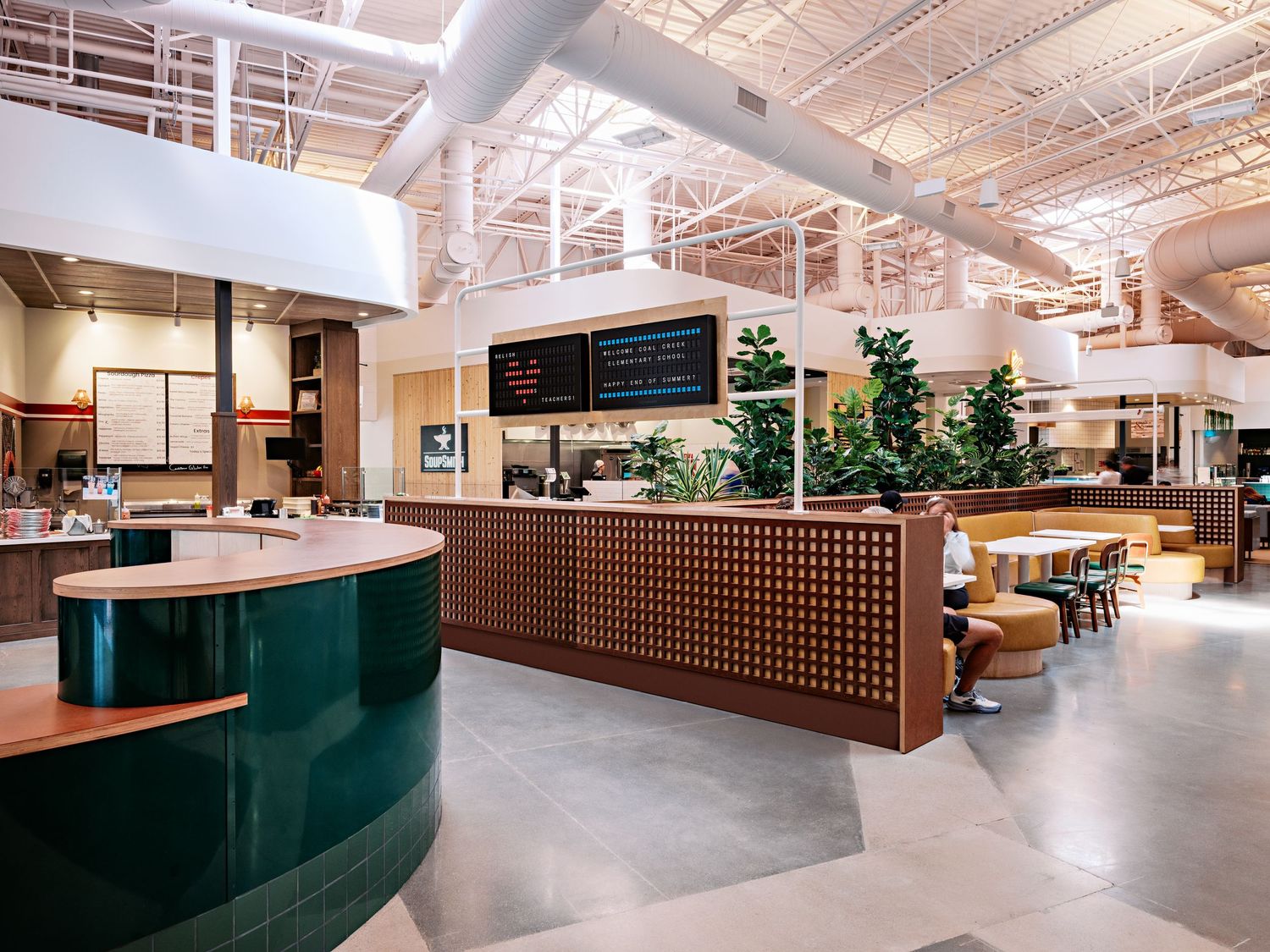 Open concept commercial space with wood accents and teal design elements.