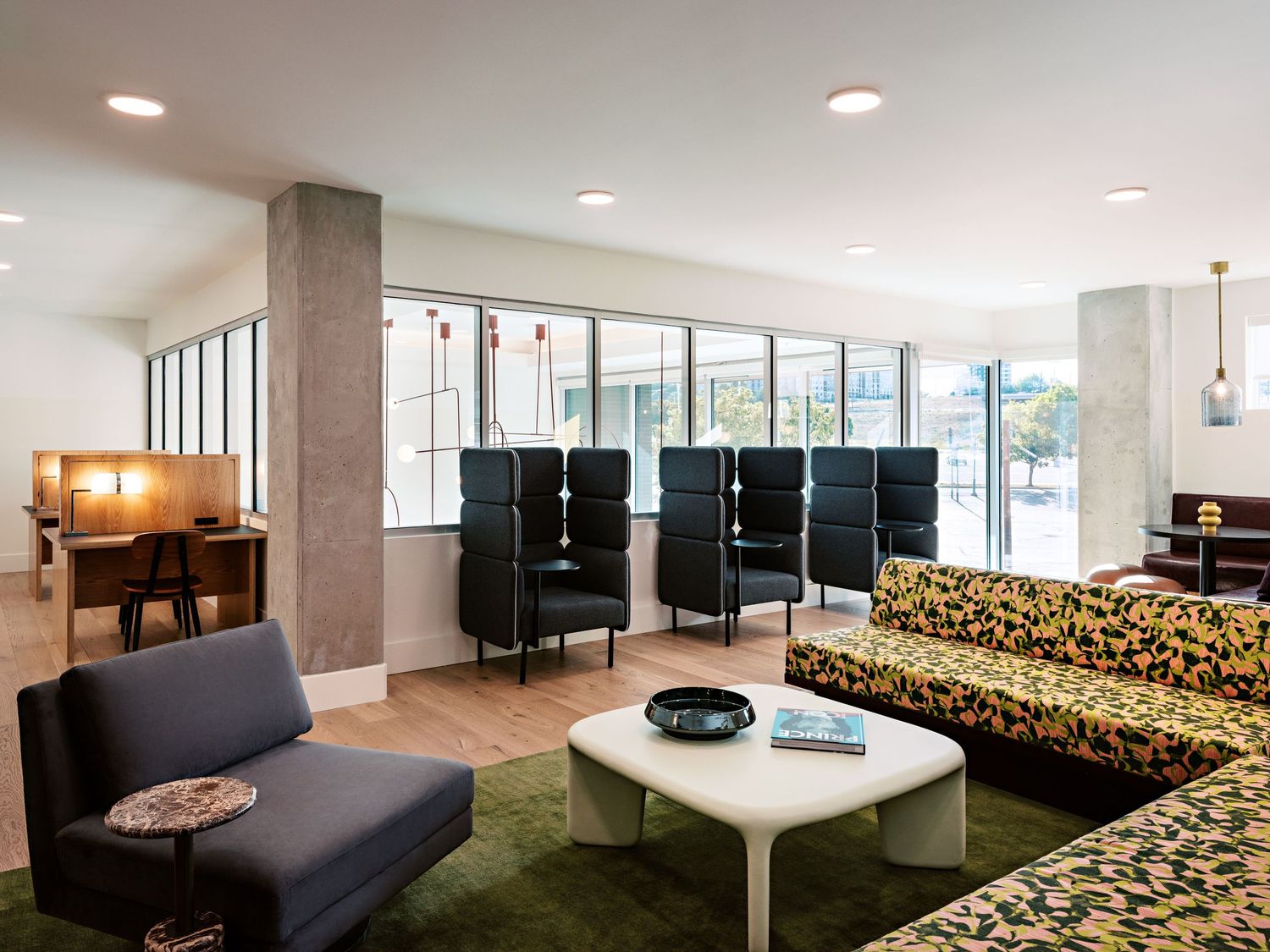 Contemporary lounge space with patterned seating and white coffee table.