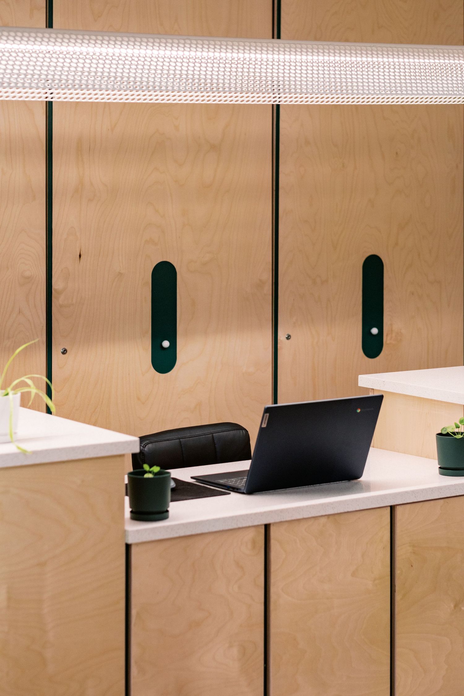 Wood-paneled wall with integrated shelving and lighting system.