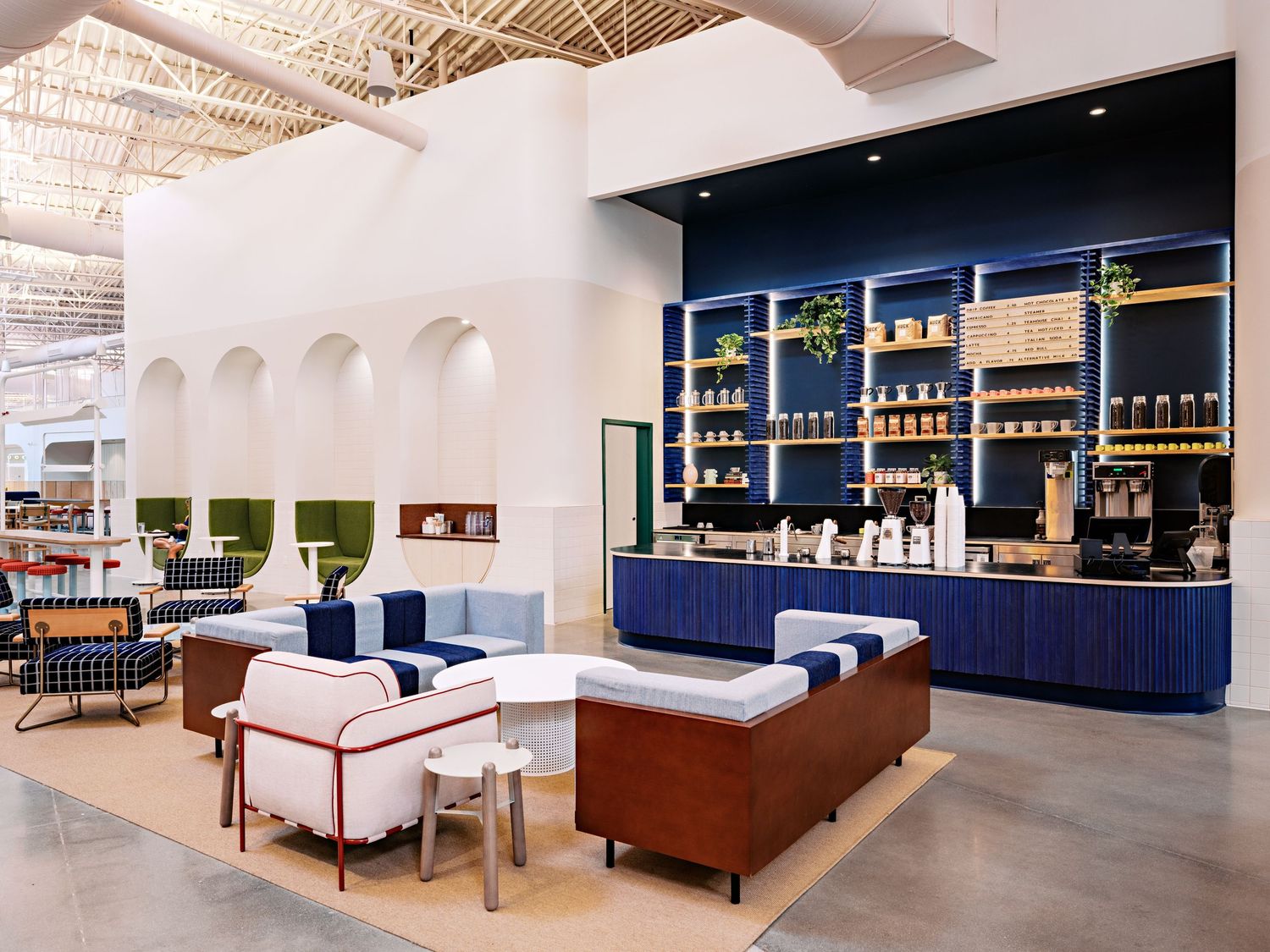Modern lounge space with navy blue accents and comfortable seating arrangements.