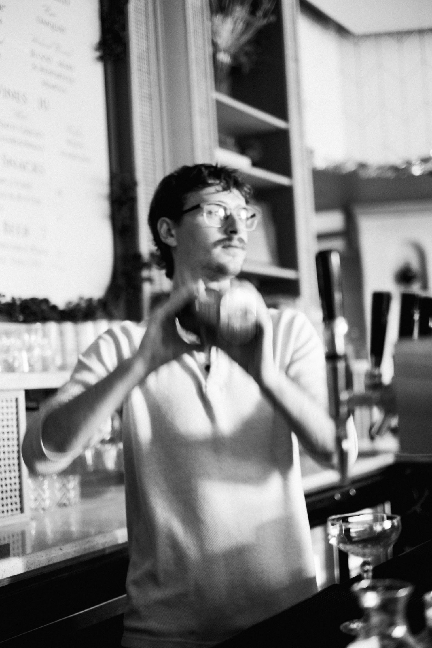 Black and white candid cafe scene in artistic blur.