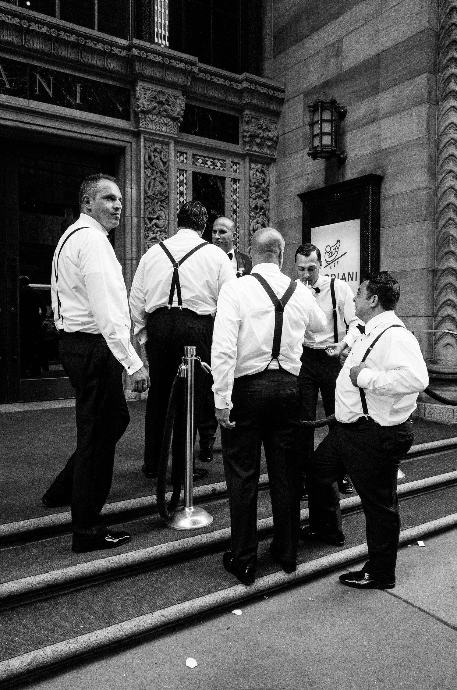 A sequence of black and white photos showing a group of people in white shirts and black pants standing on stairs.