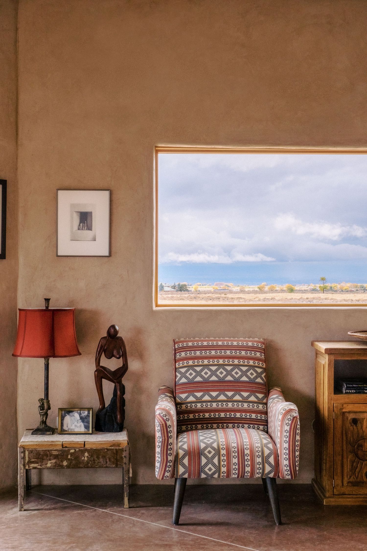 Southwestern style room interior with traditional patterned furniture and adobe walls.