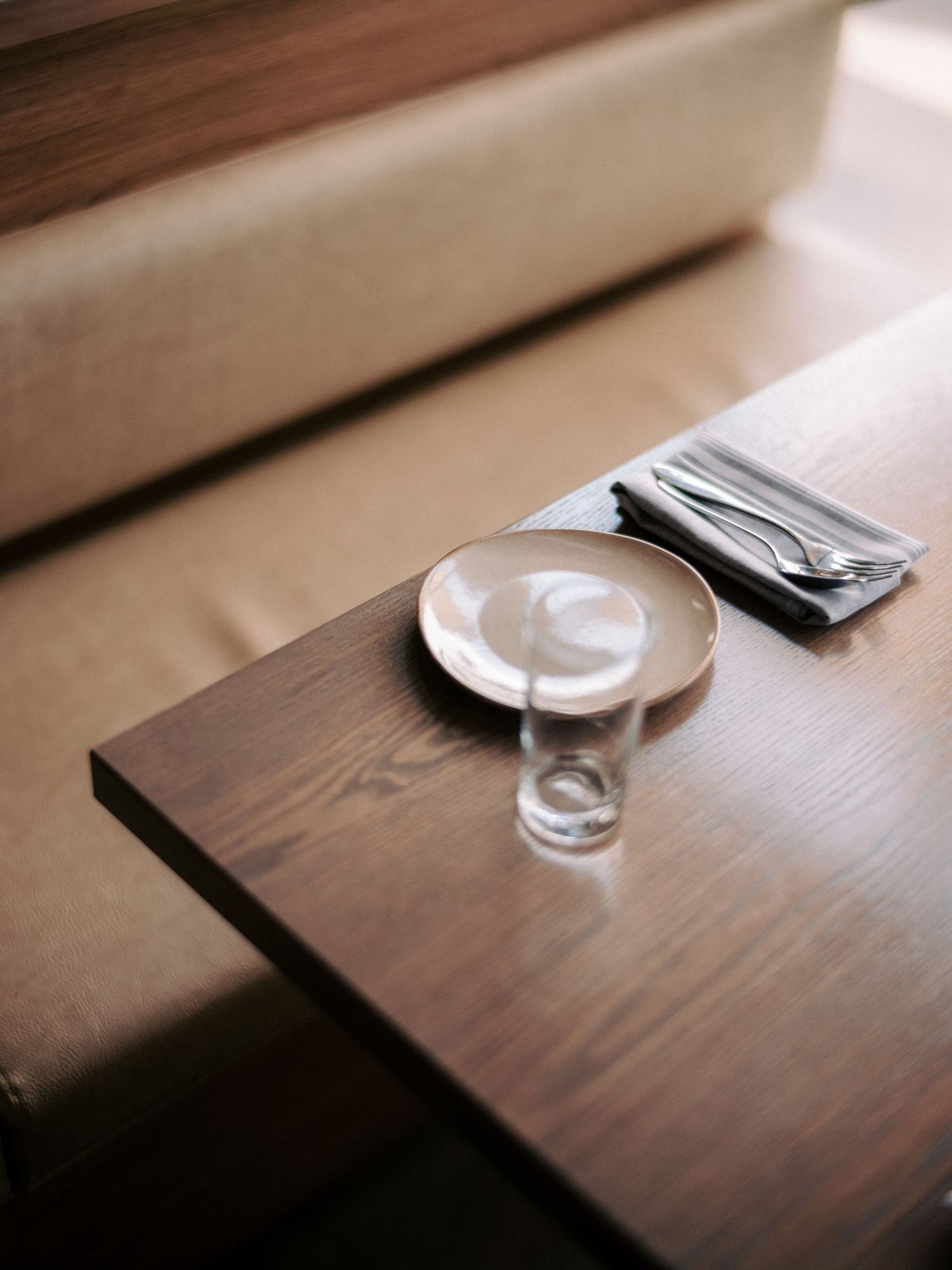 Glass tableware on dark wooden surface with minimalist styling.