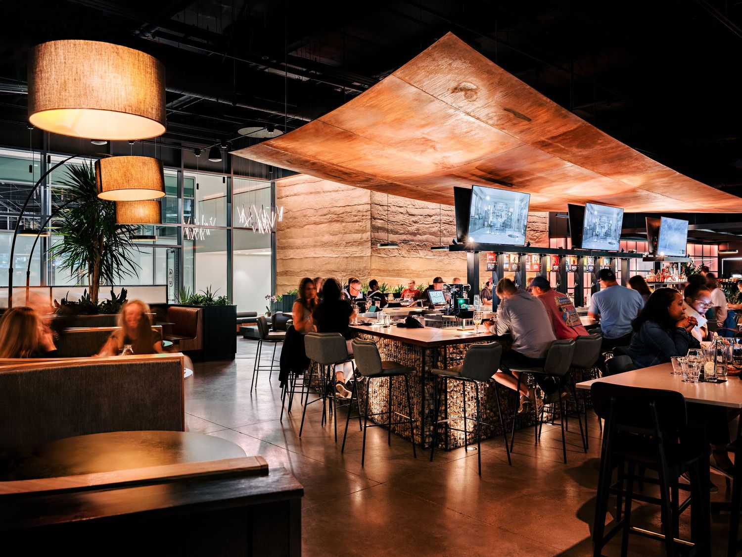 Contemporary dining space with hanging pendant lights and comfortable seating arrangements.