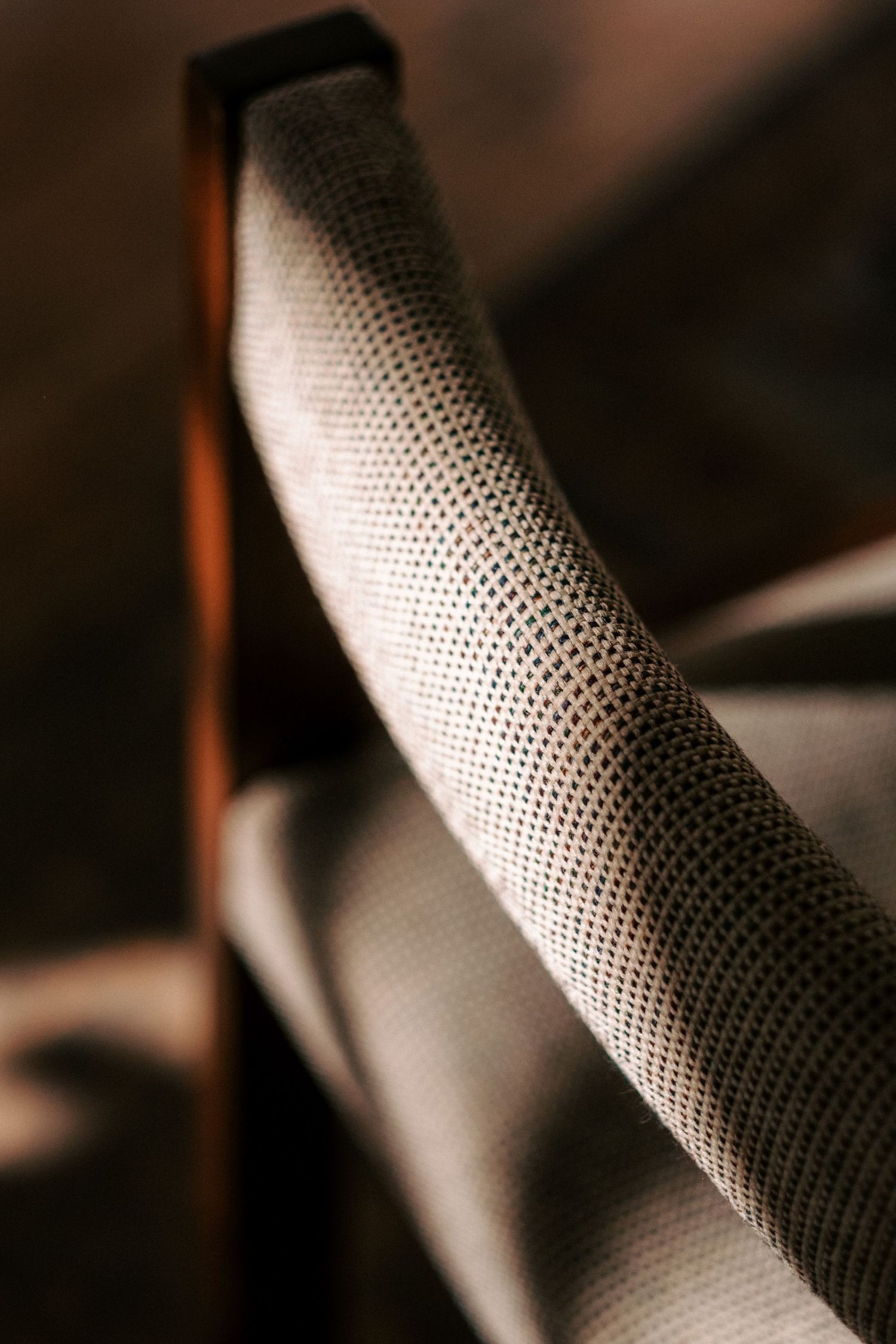 Close-up detail of textured gray upholstery fabric on furniture.