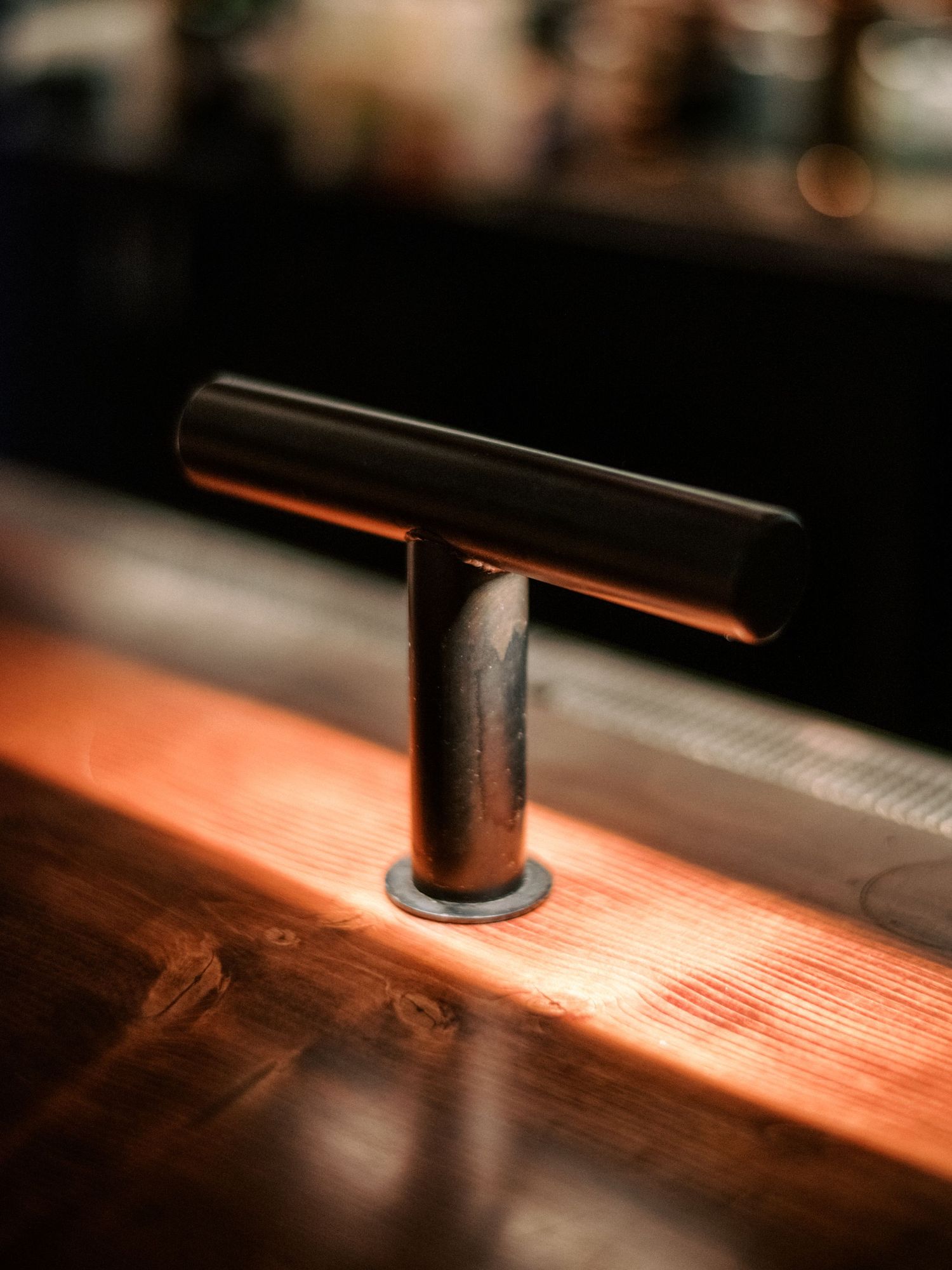 Close-up view of a wooden surface with dramatic red lighting and shadows.