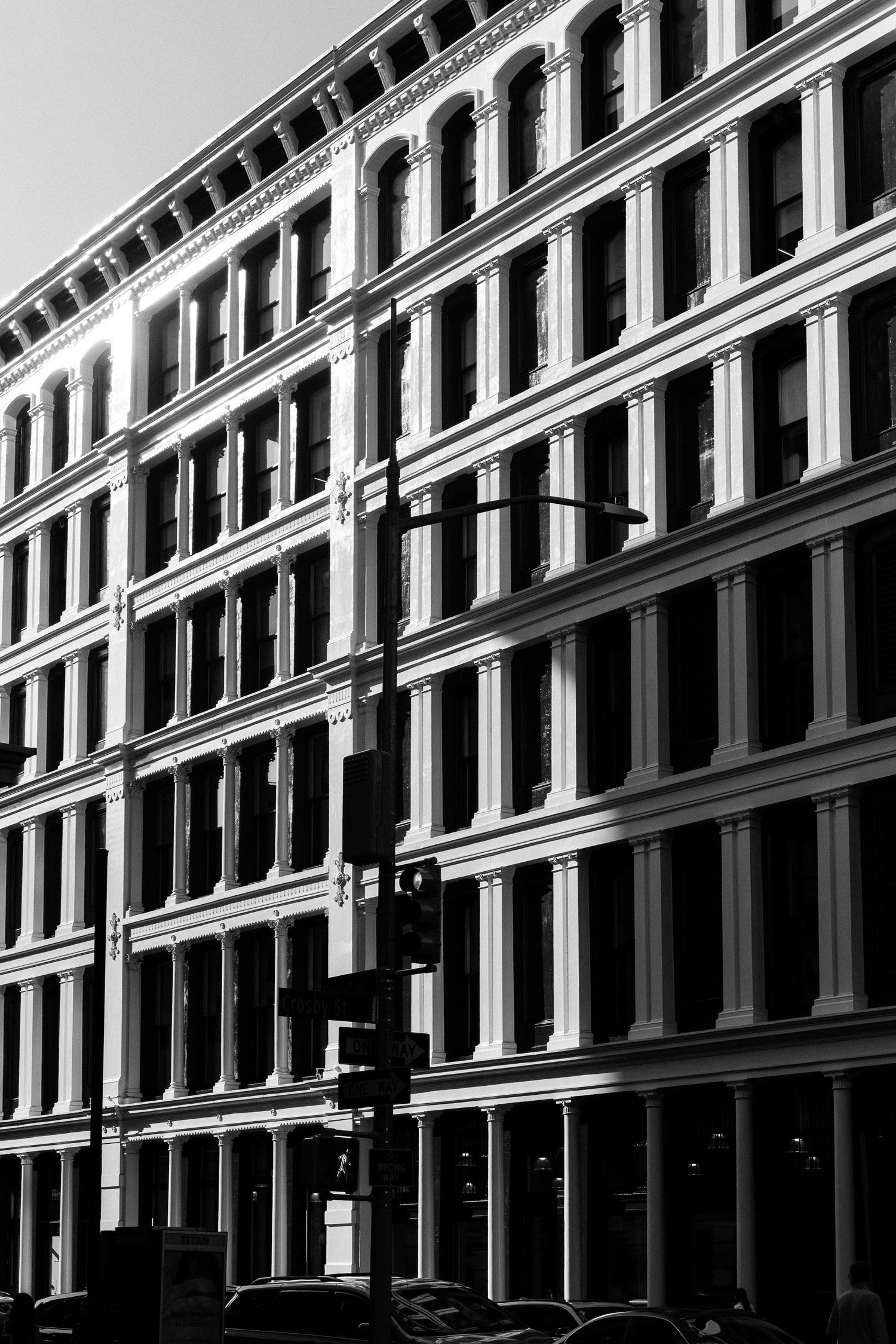 Black and white architectural detail of a historic building facade with repeating windows and columns.