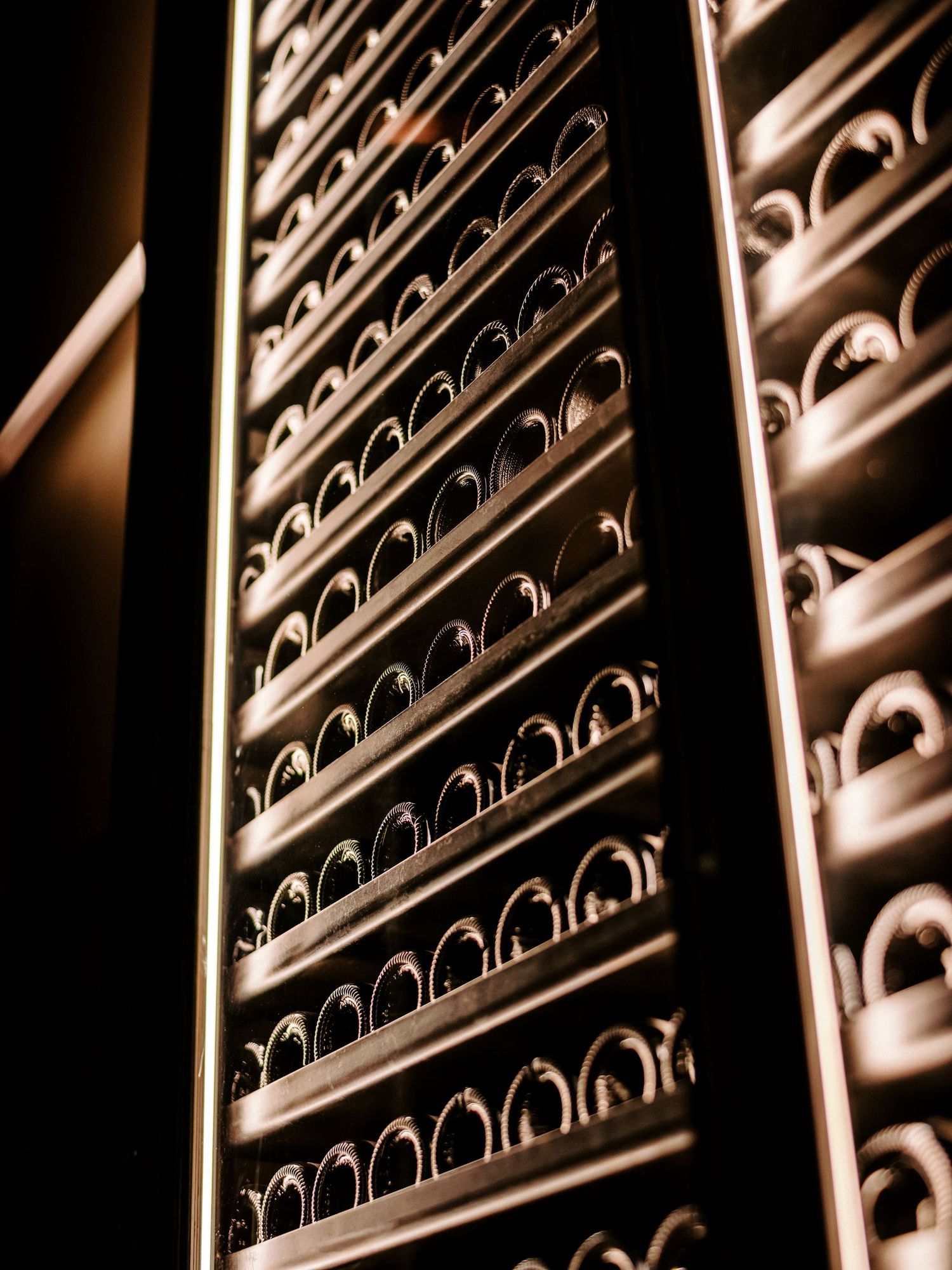 Decorative metal grating pattern with curved lines creating an elegant architectural detail in warm lighting.