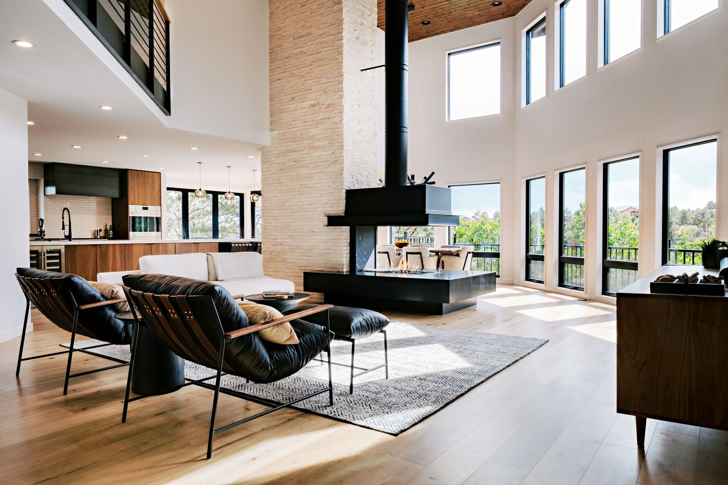 Panoramic mountain views through large windows in modern open-plan living space.