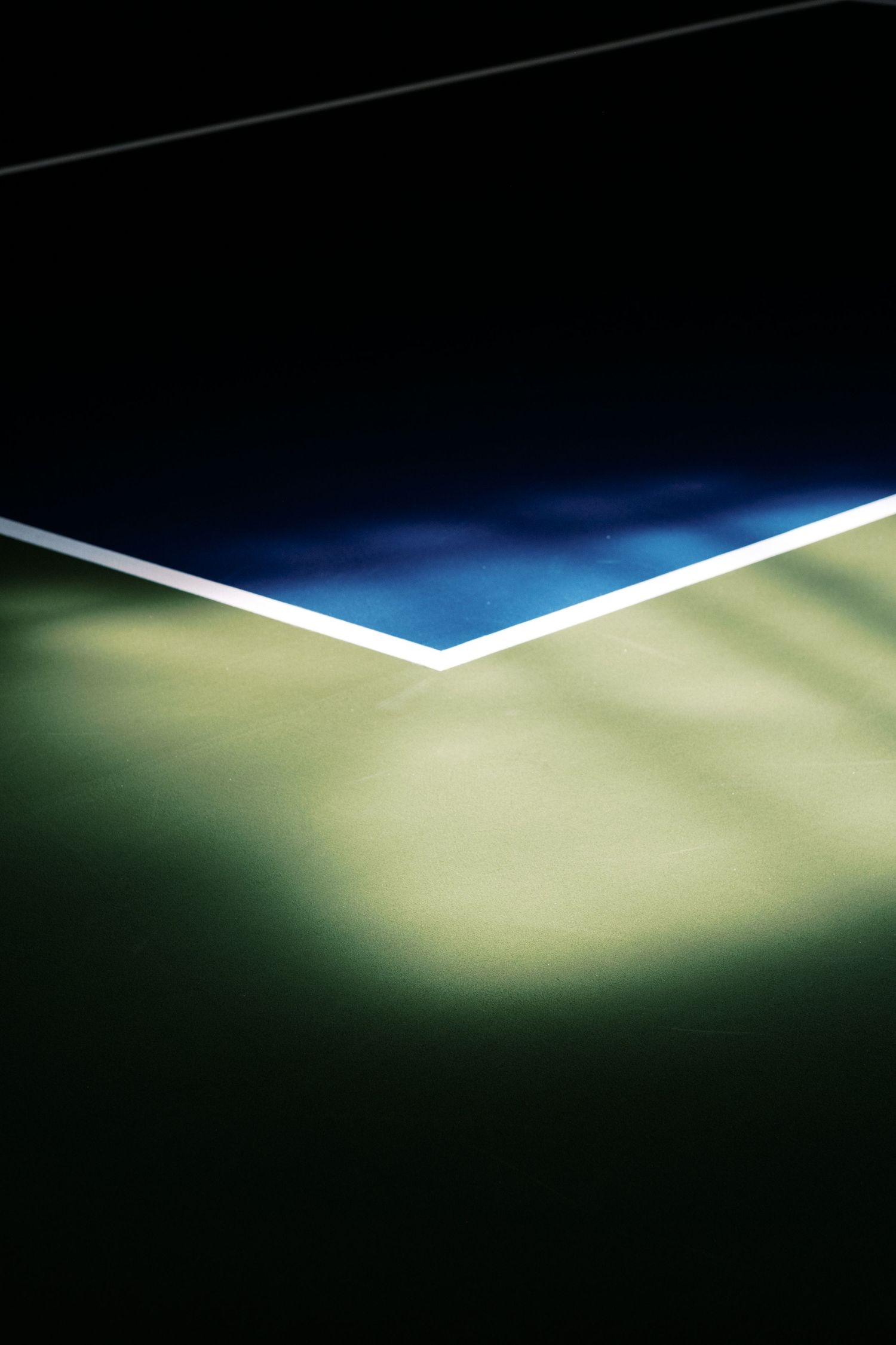 Abstract geometric composition showing blue and beige tennis court lines and surfaces.