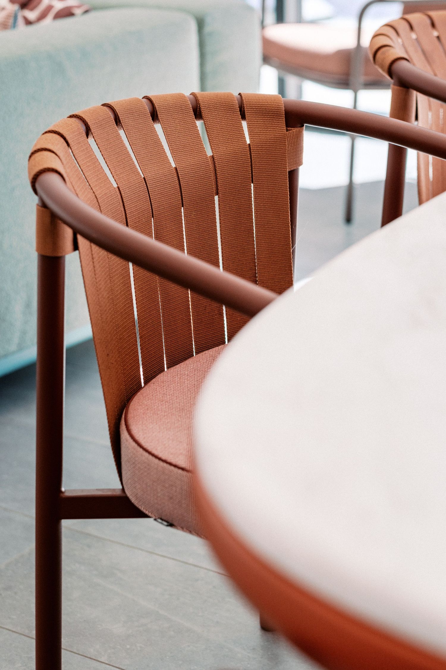 Close-up of leather woven chair back detail in brown tones.