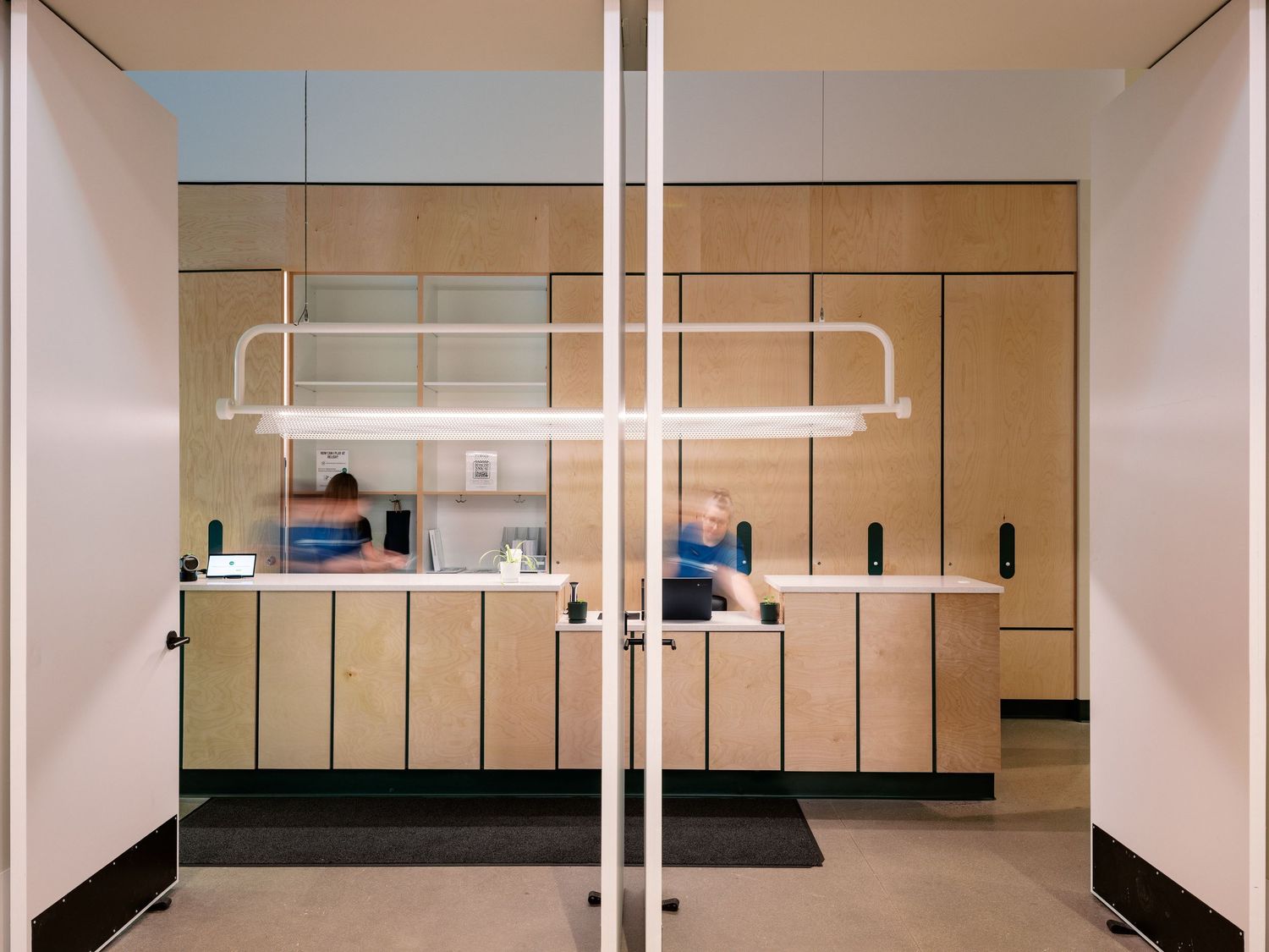 Minimalist interior space with clean lines and suspended lighting fixtures.