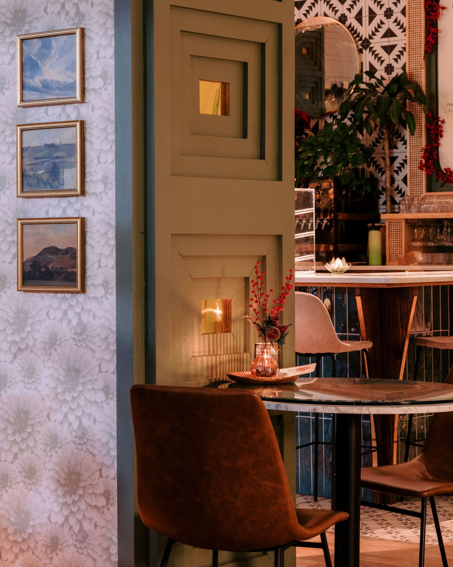 Cozy restaurant interior with framed artwork and warm lighting creating an intimate atmosphere.