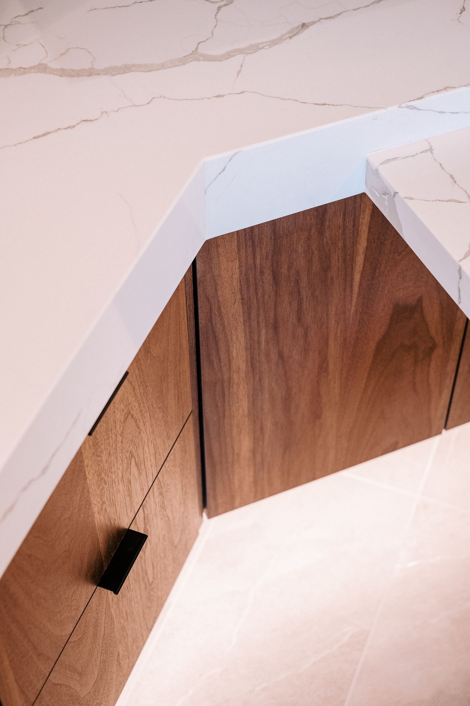 Minimalist architectural detail showing curved white ceiling meeting wooden wall panels.