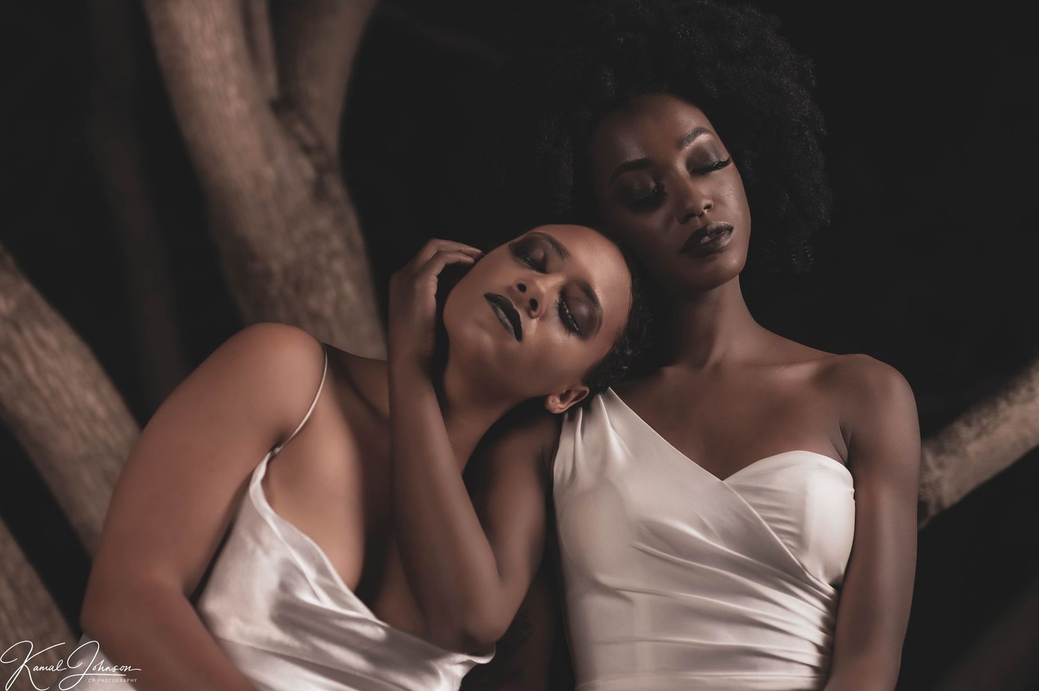 Dramatic portrait series featuring white dress and expressive poses in low light.
