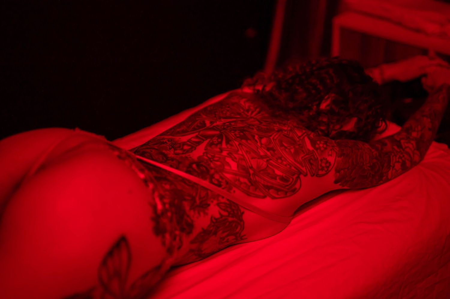 Abstract red-tinted photography with soft focus and dramatic shadows.
