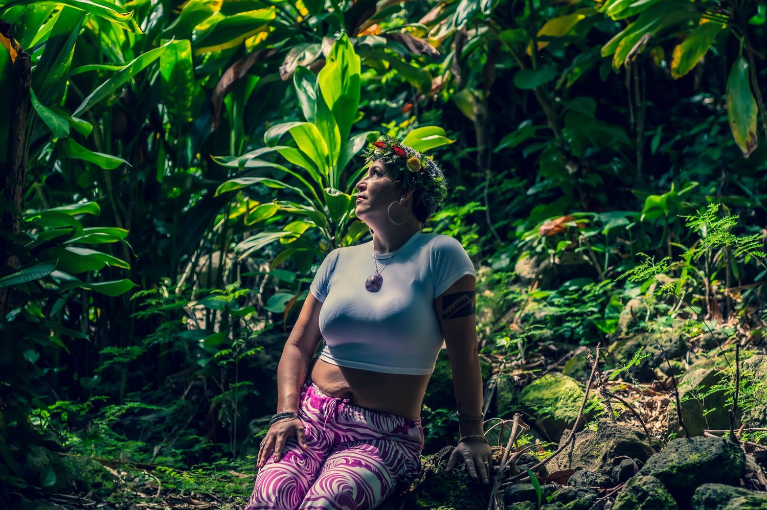 Candid moments captured in a tropical garden setting with lush green foliage.