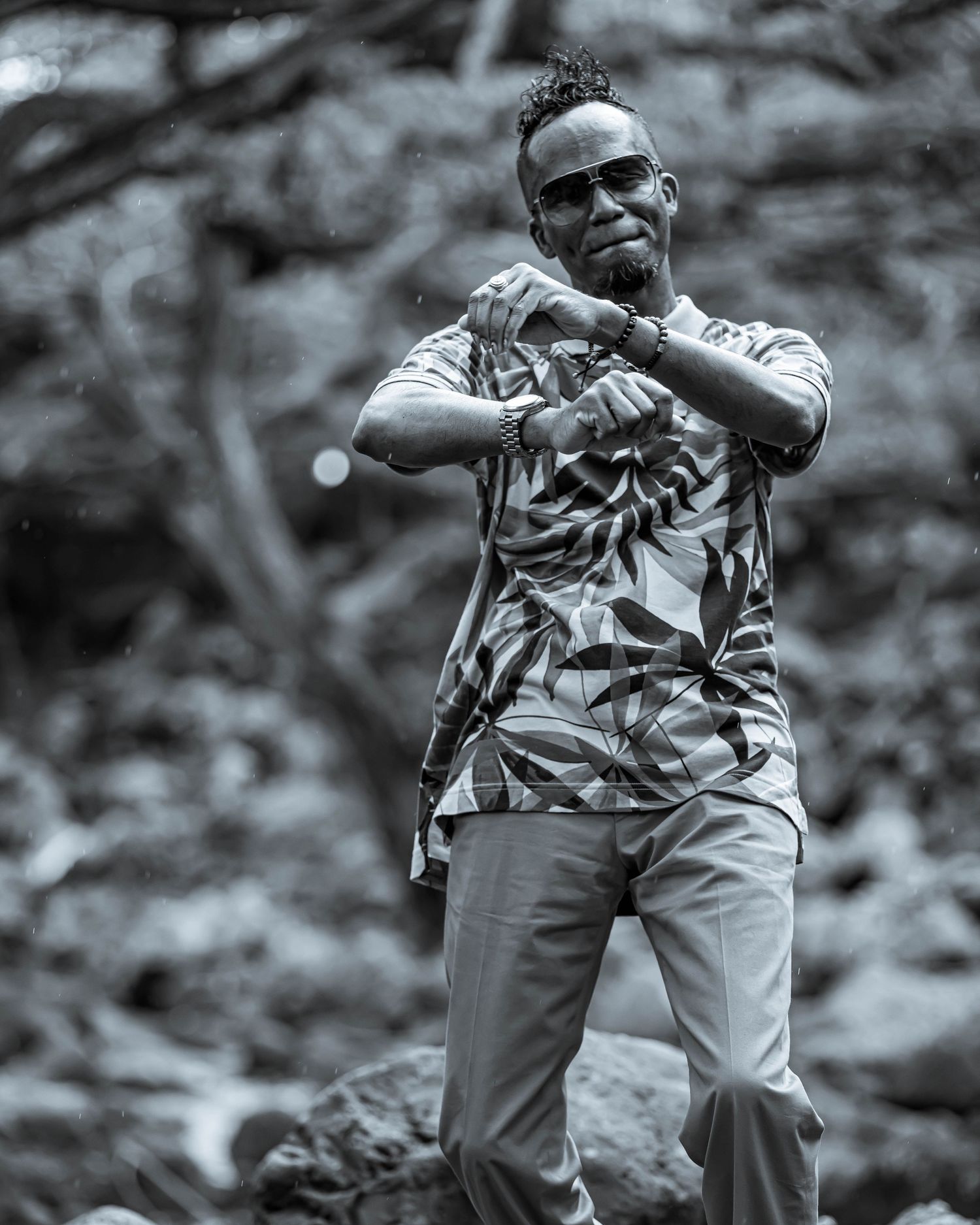 Black and white action sequence of baseball player swinging bat during practice.