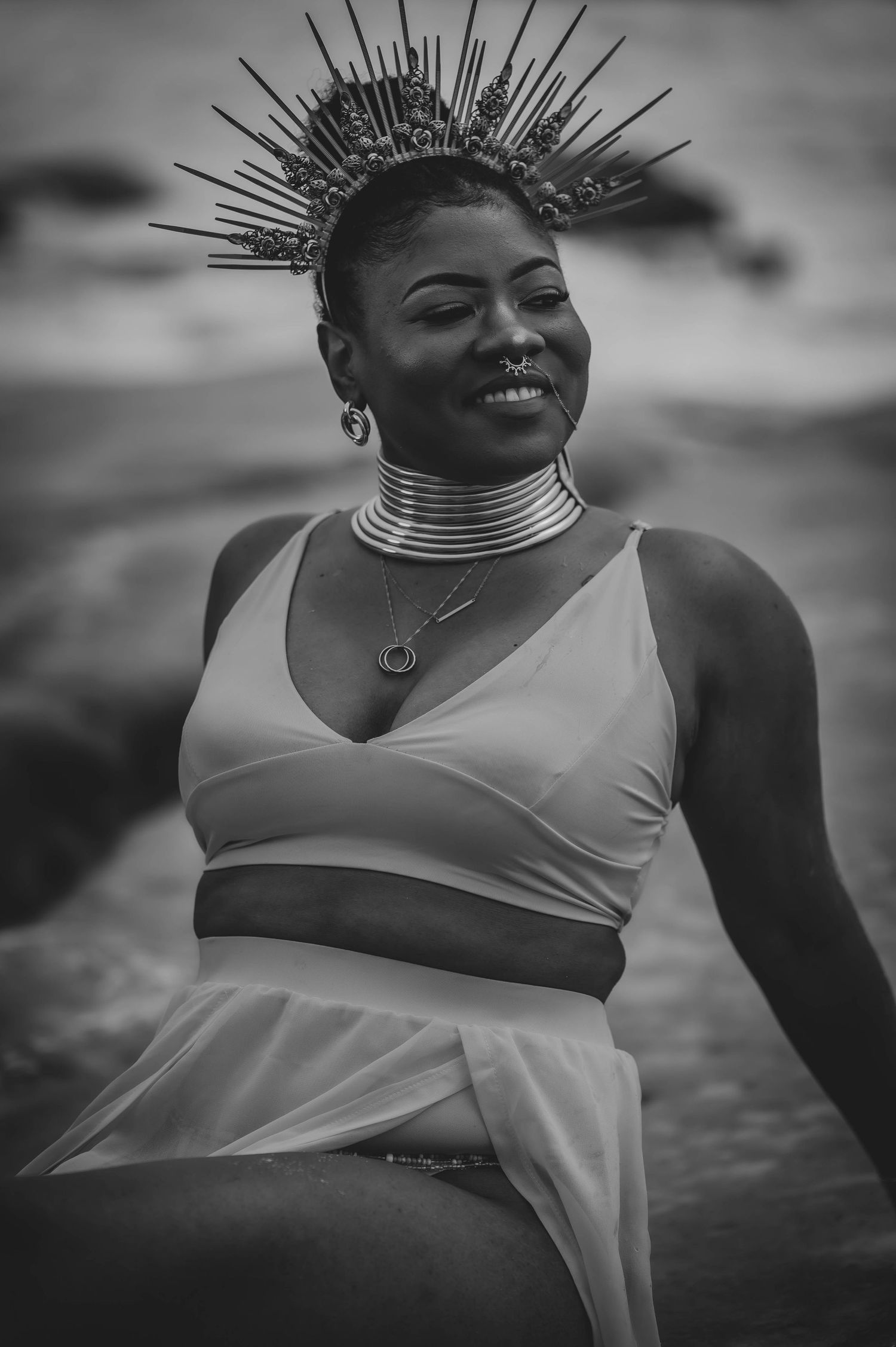 Black and white portrait series featuring dramatic spiked crown headpiece and white top.