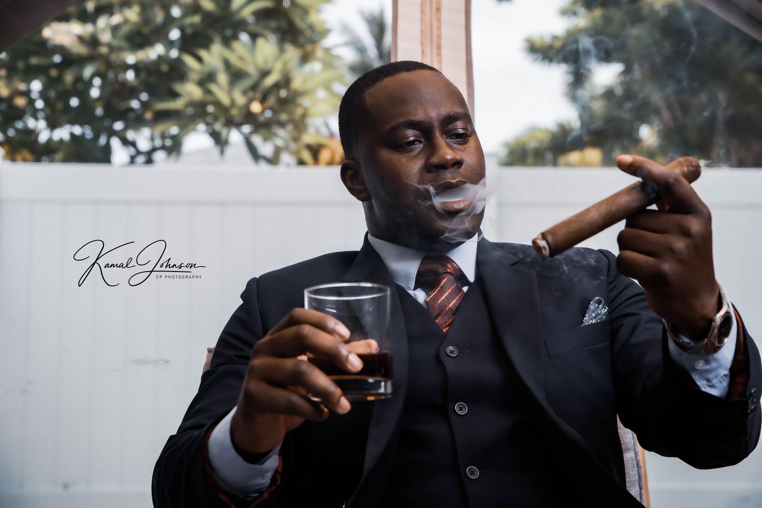 Artistic photo sequence of someone in a suit smoking a cigar against a light background.