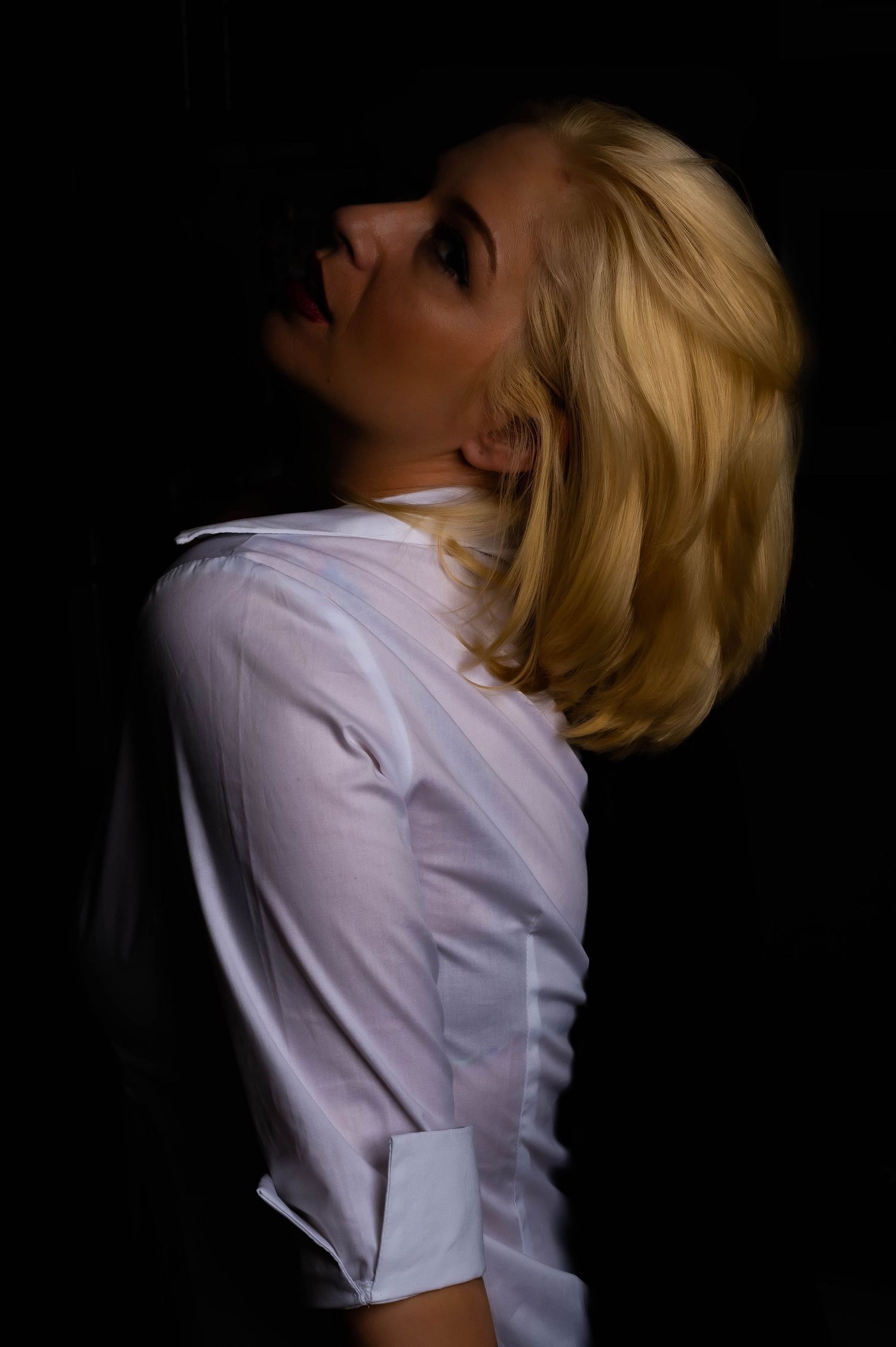 Dramatic black and white portraits showing expressive poses against dark background.