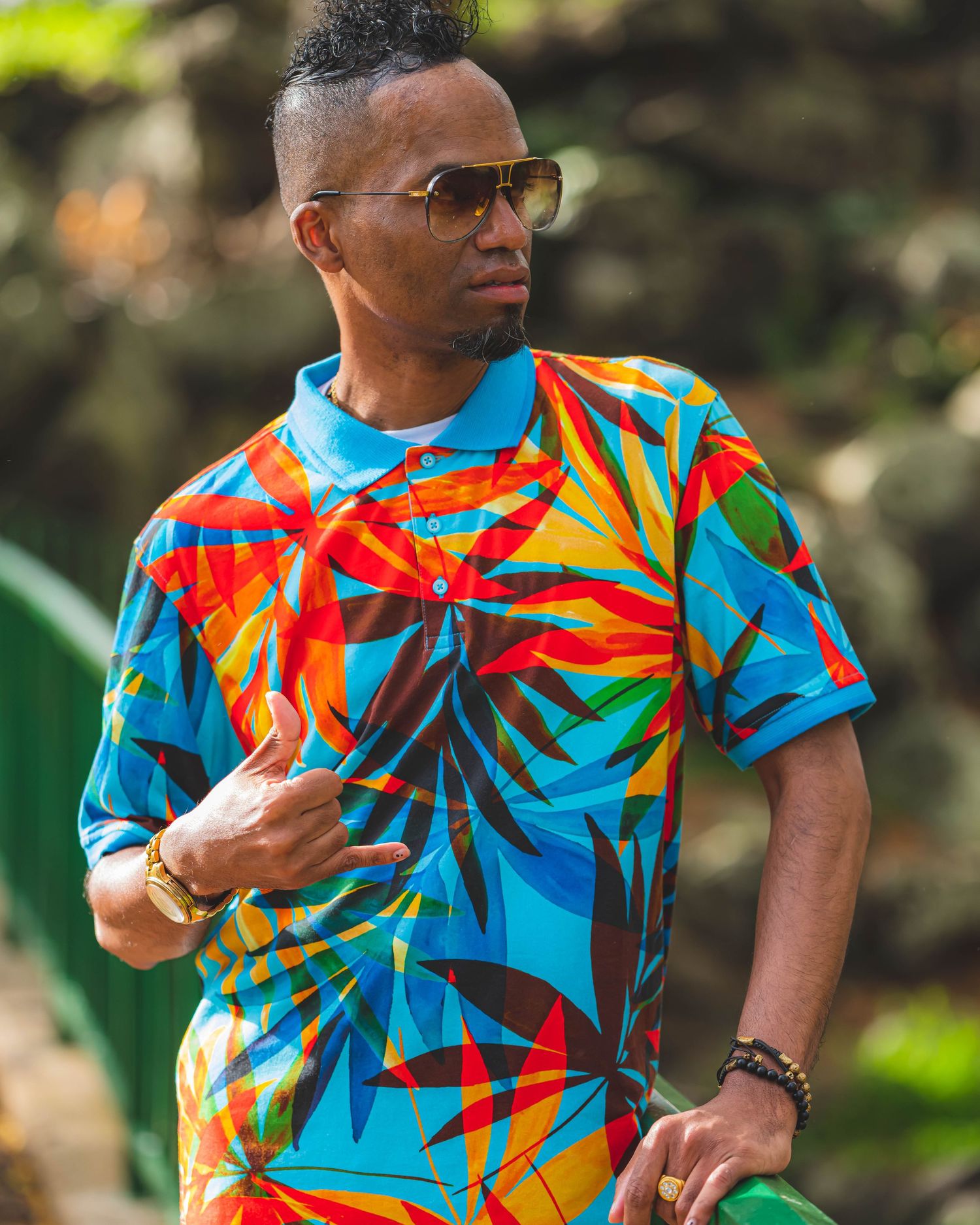 Colorful tropical print t-shirt with vibrant blue and orange geometric patterns.